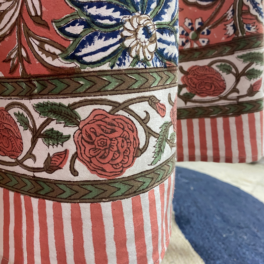 Decorative fabric with floral and striped patterns in red, blue, and green.