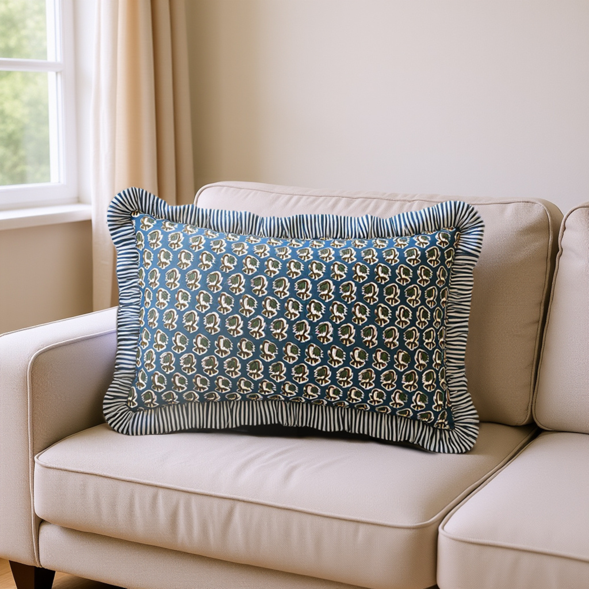 Decorative pillow with blue and gold pattern on a beige sofa by a window.