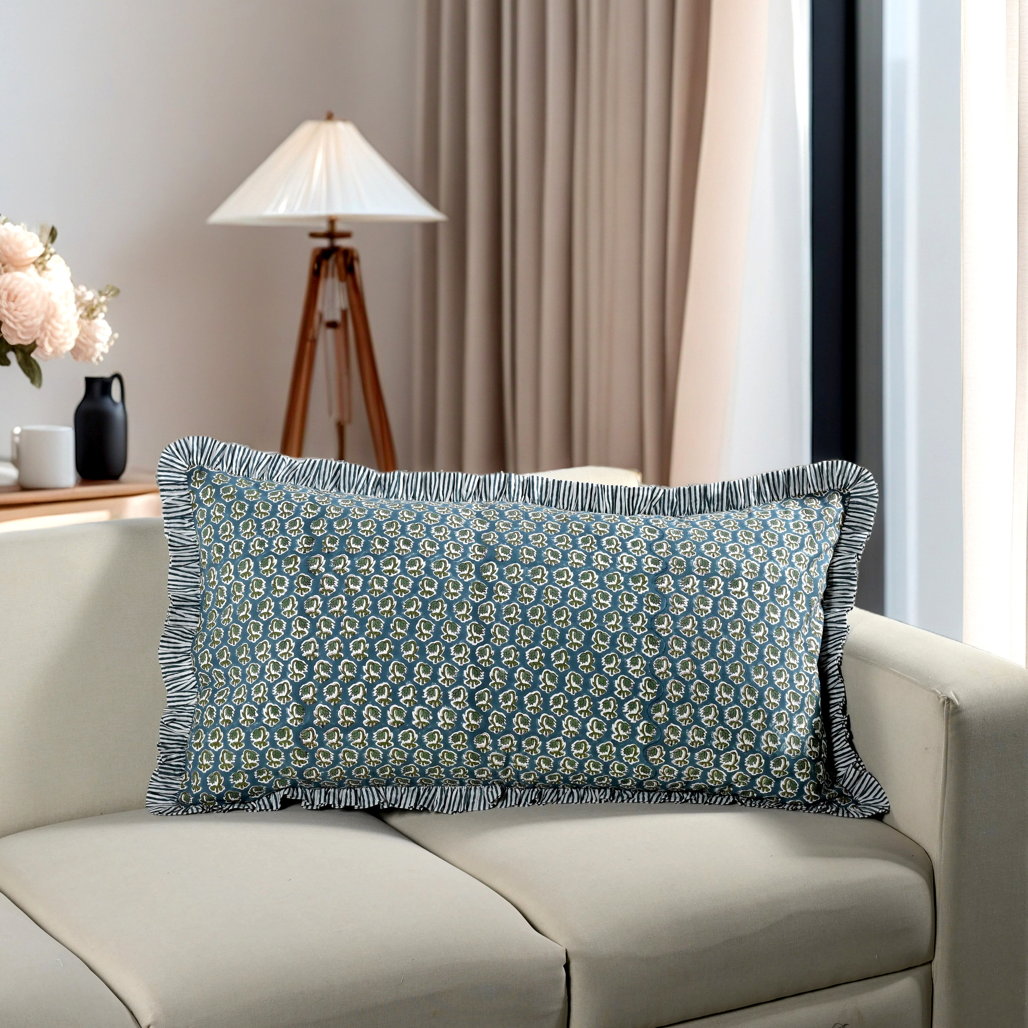 Blue floral block print cotton pillow styled on a beige sofa in living room.