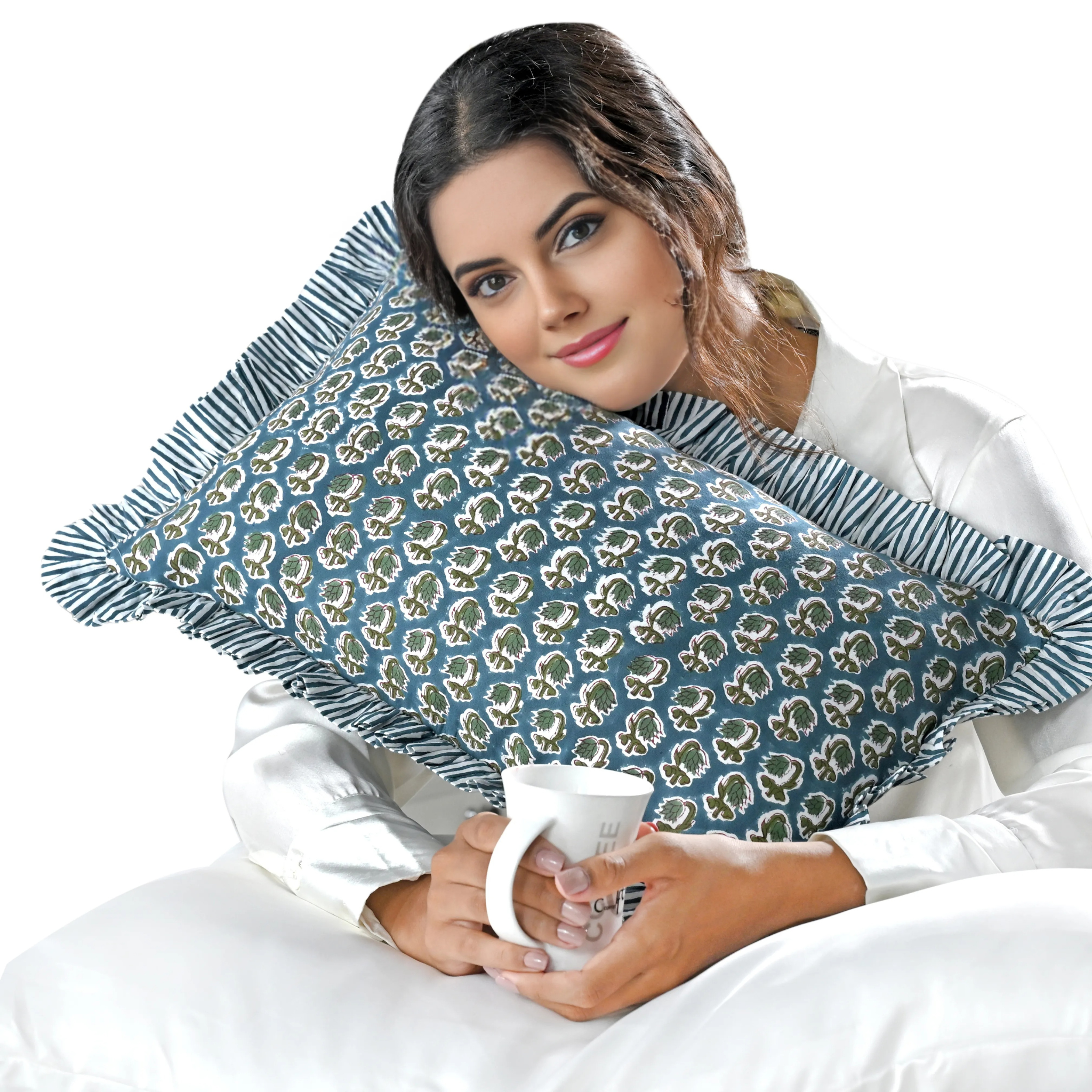 Woman holding a blue patterned pillow and a white mug on a white background