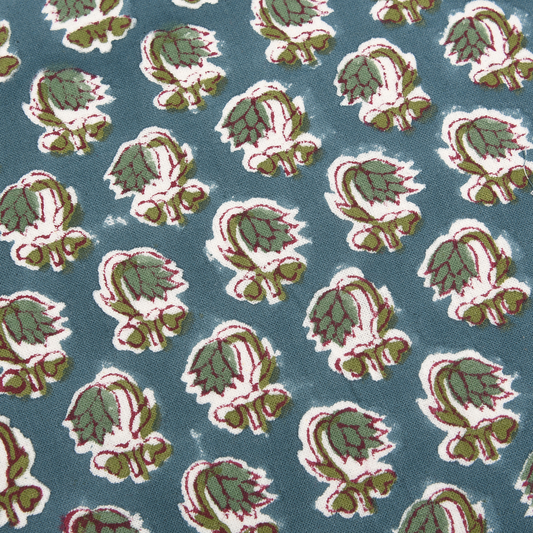Pattern of green and red leaves on a blue background