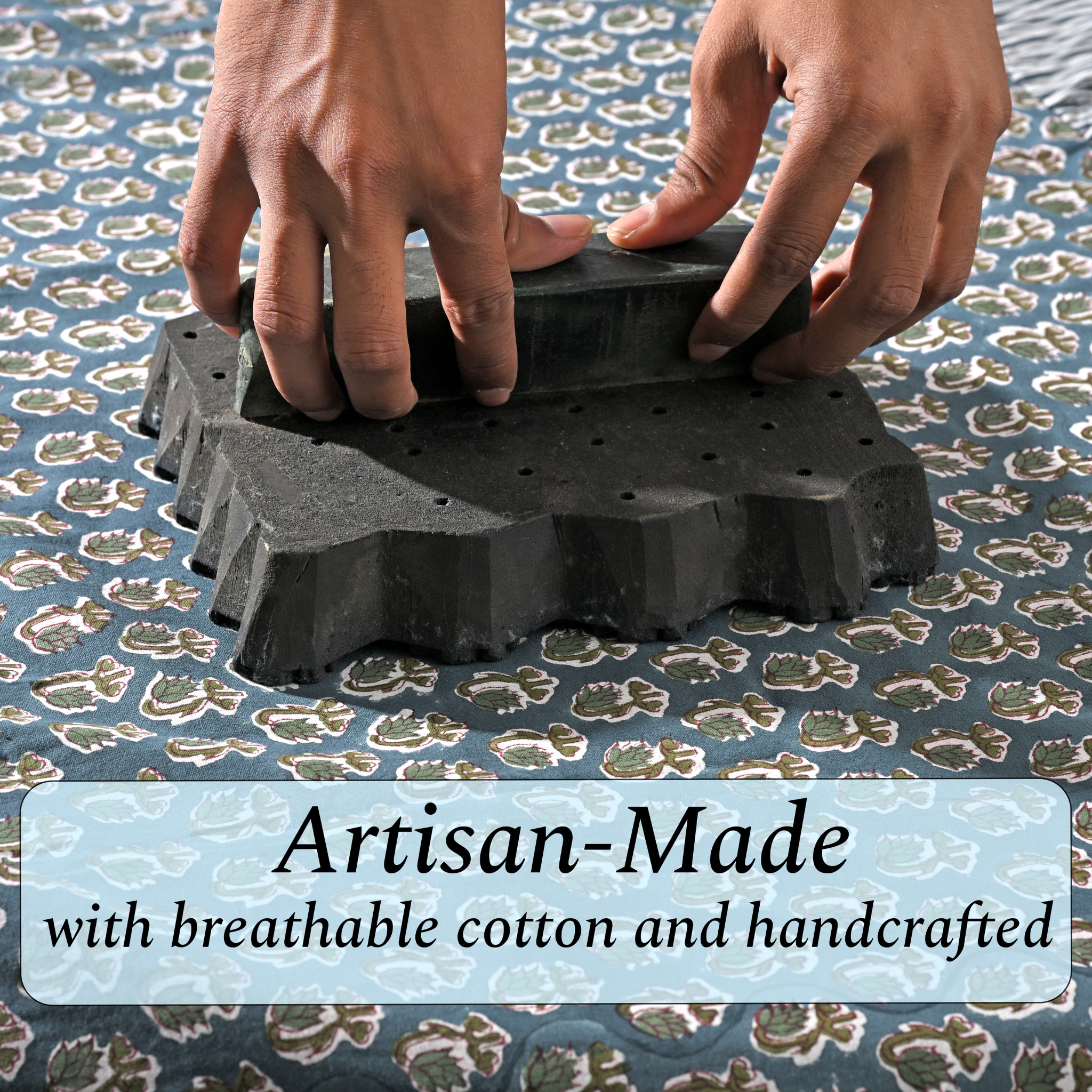 Artisan hand-block printing floral design on cotton fabric.