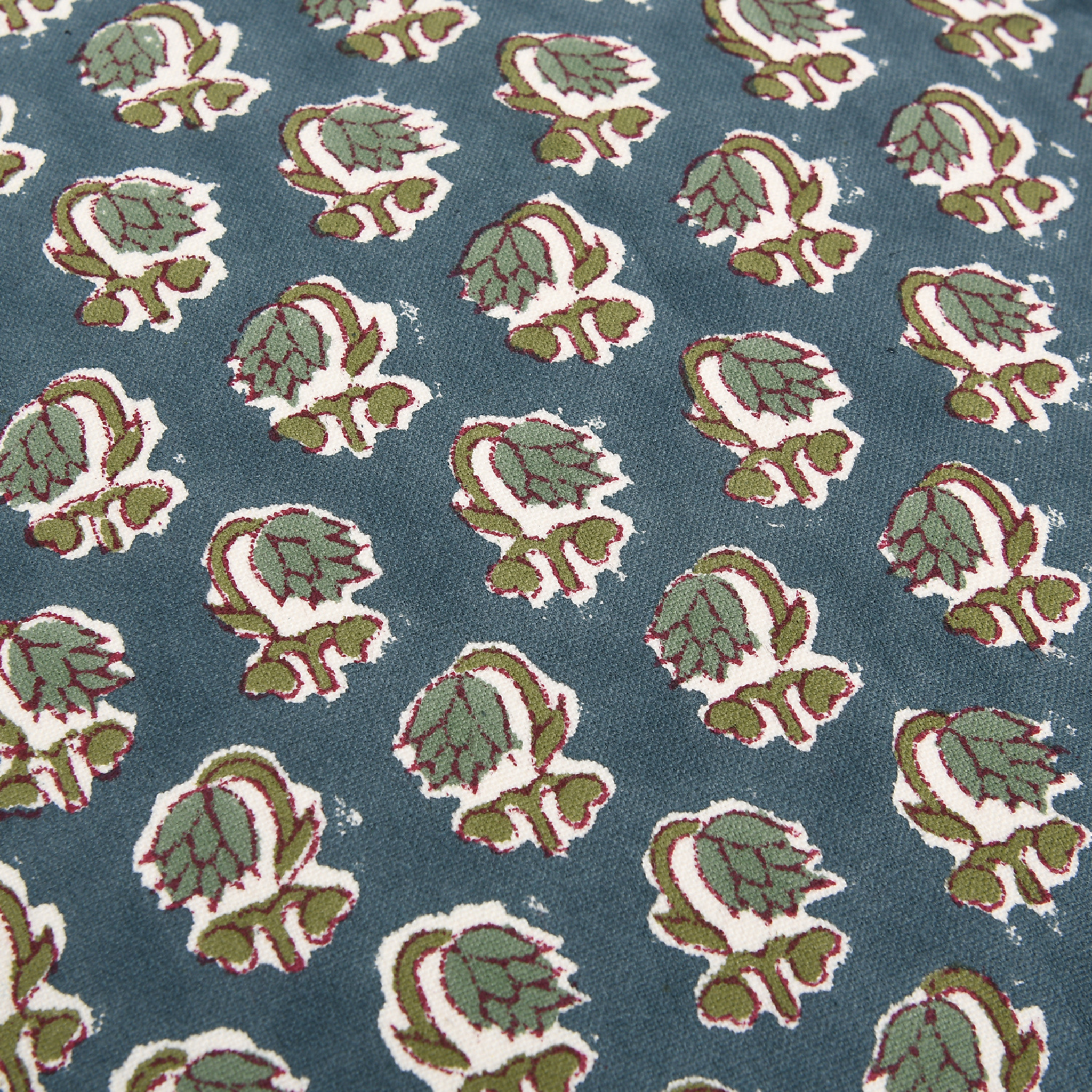 Pattern of green and white leaves on a blue background