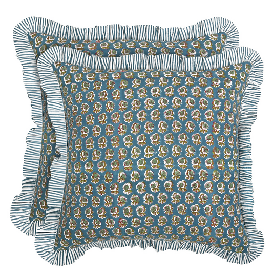 Decorative pillow with floral pattern and ruffled edge on a white background