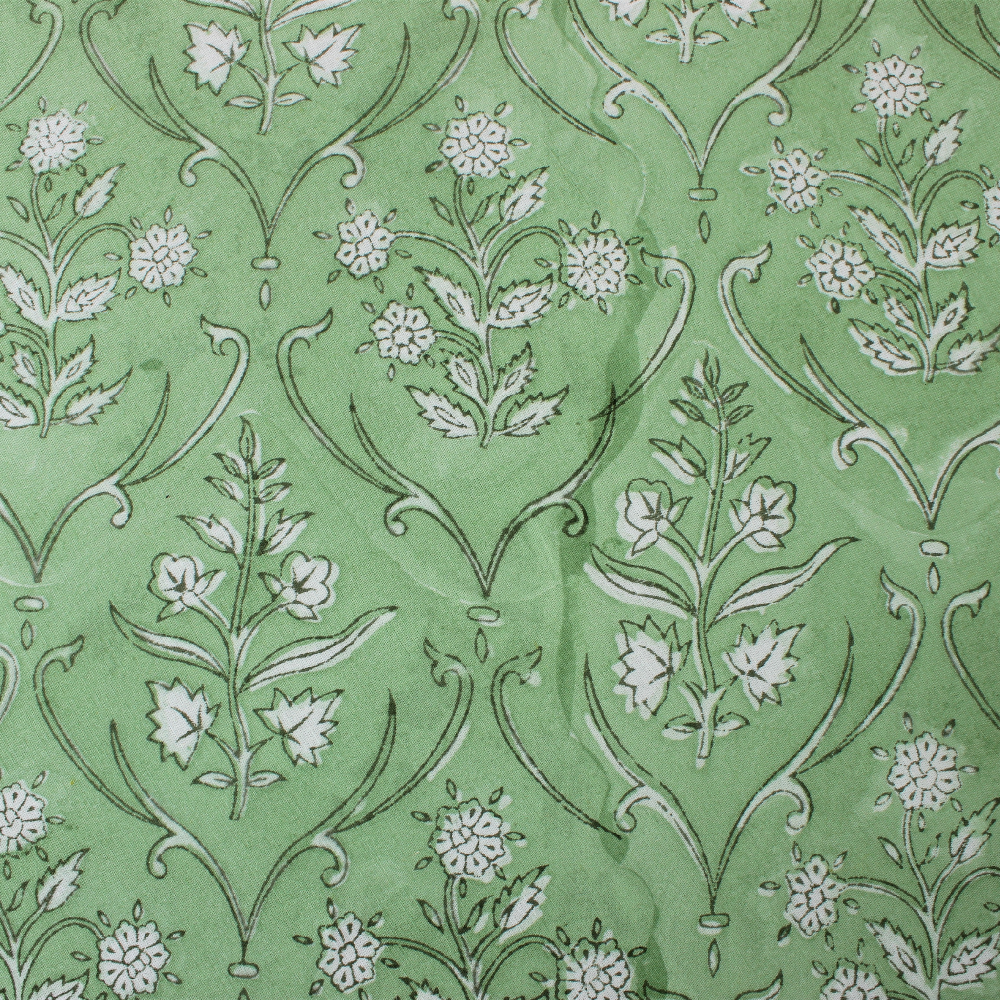 Floral pattern with white flowers and green leaves on a green background