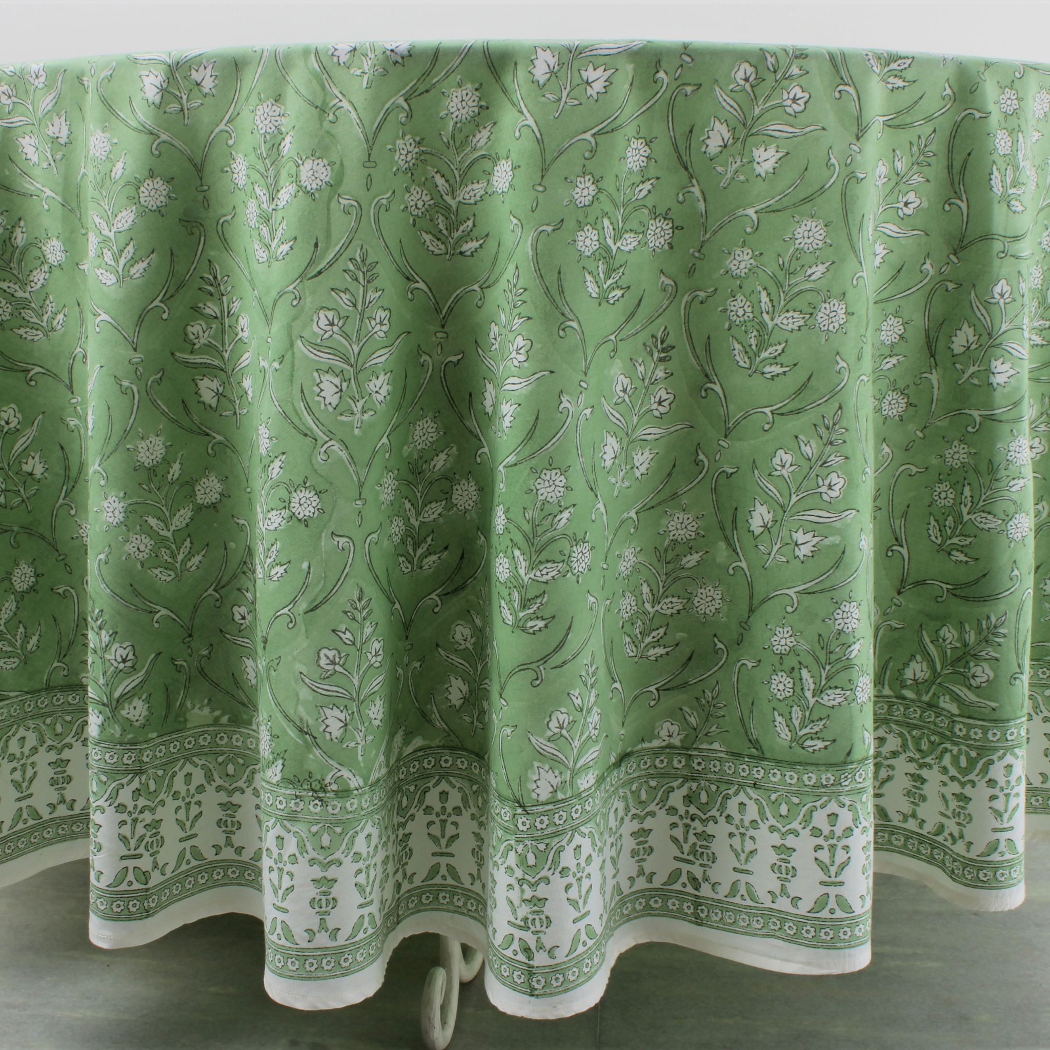 Green floral patterned tablecloth on a white background