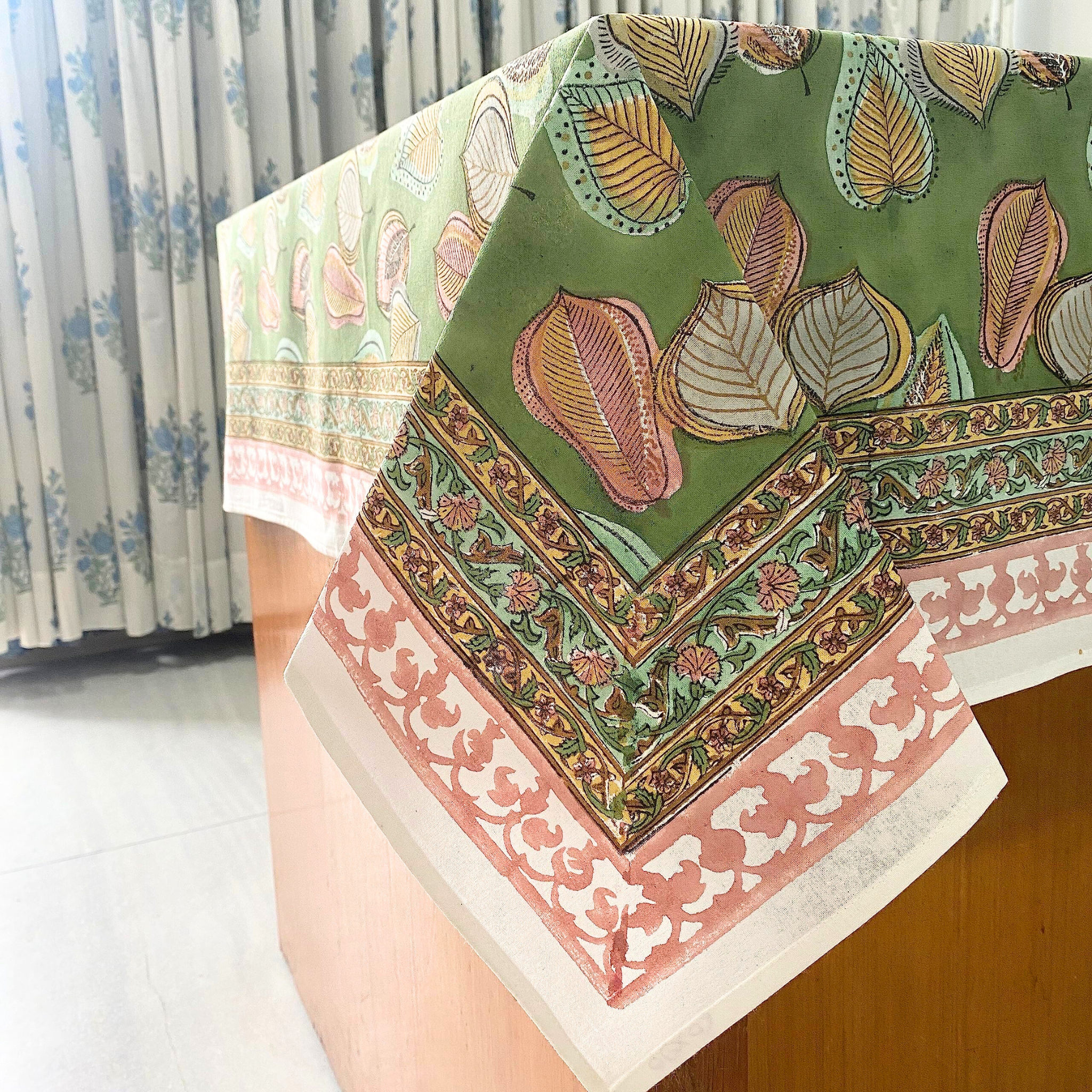 Decorative tablecloth with intricate patterns on a wooden surface.