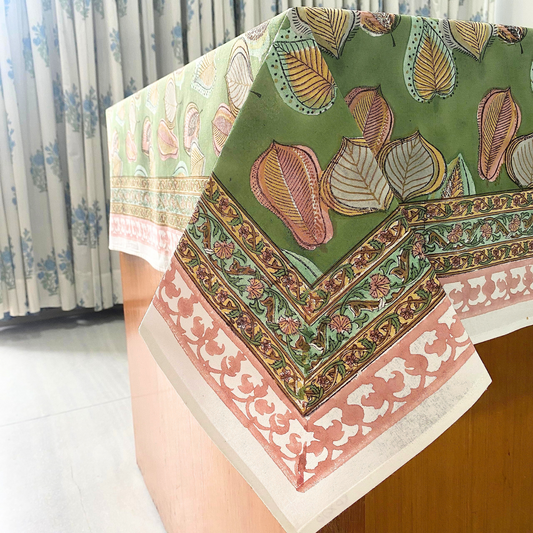 Decorative tablecloth with intricate patterns on a wooden surface.