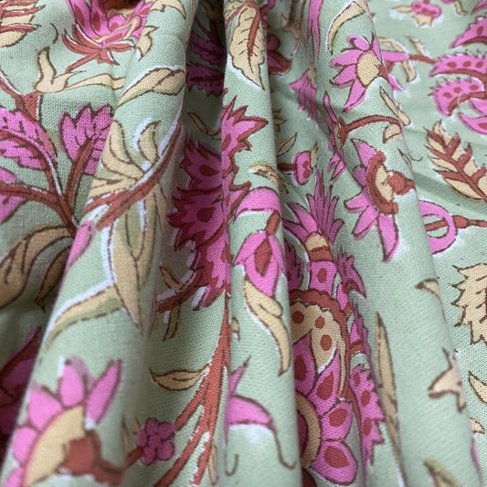 Close-up of floral fabric with pink and brown flowers on a light green background