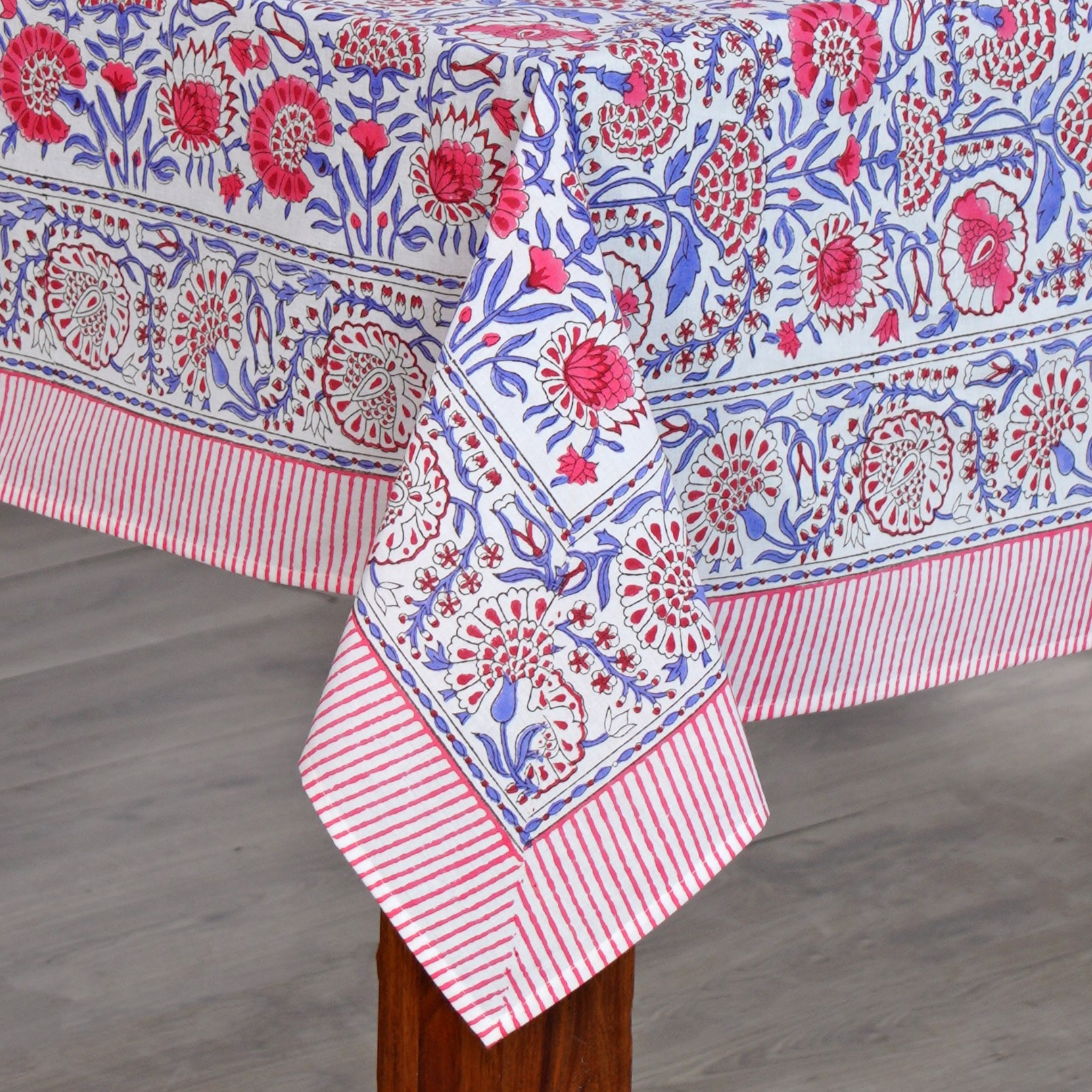 Decorative tablecloth with floral pattern on a wooden surface