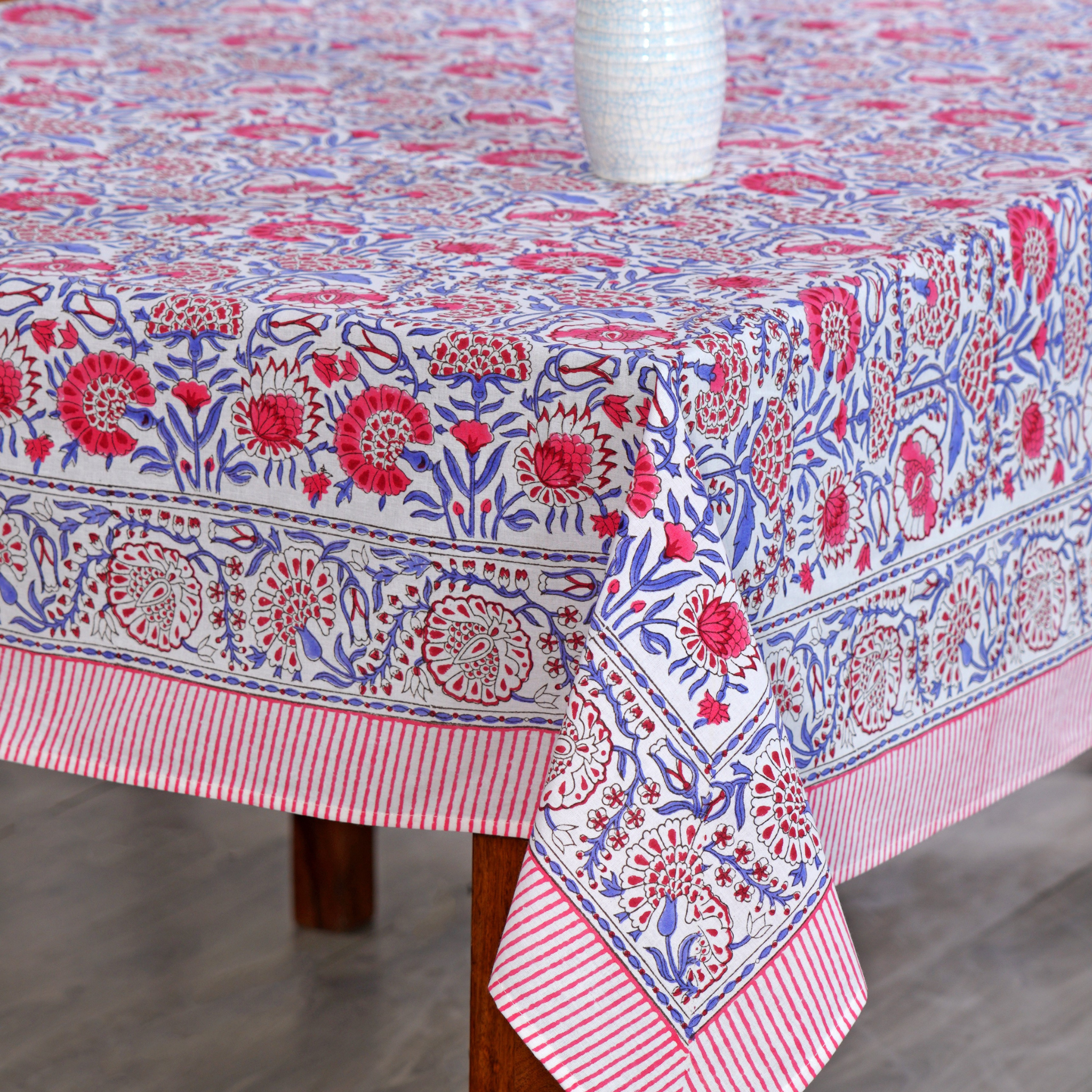 Decorative tablecloth with floral pattern on a wooden table