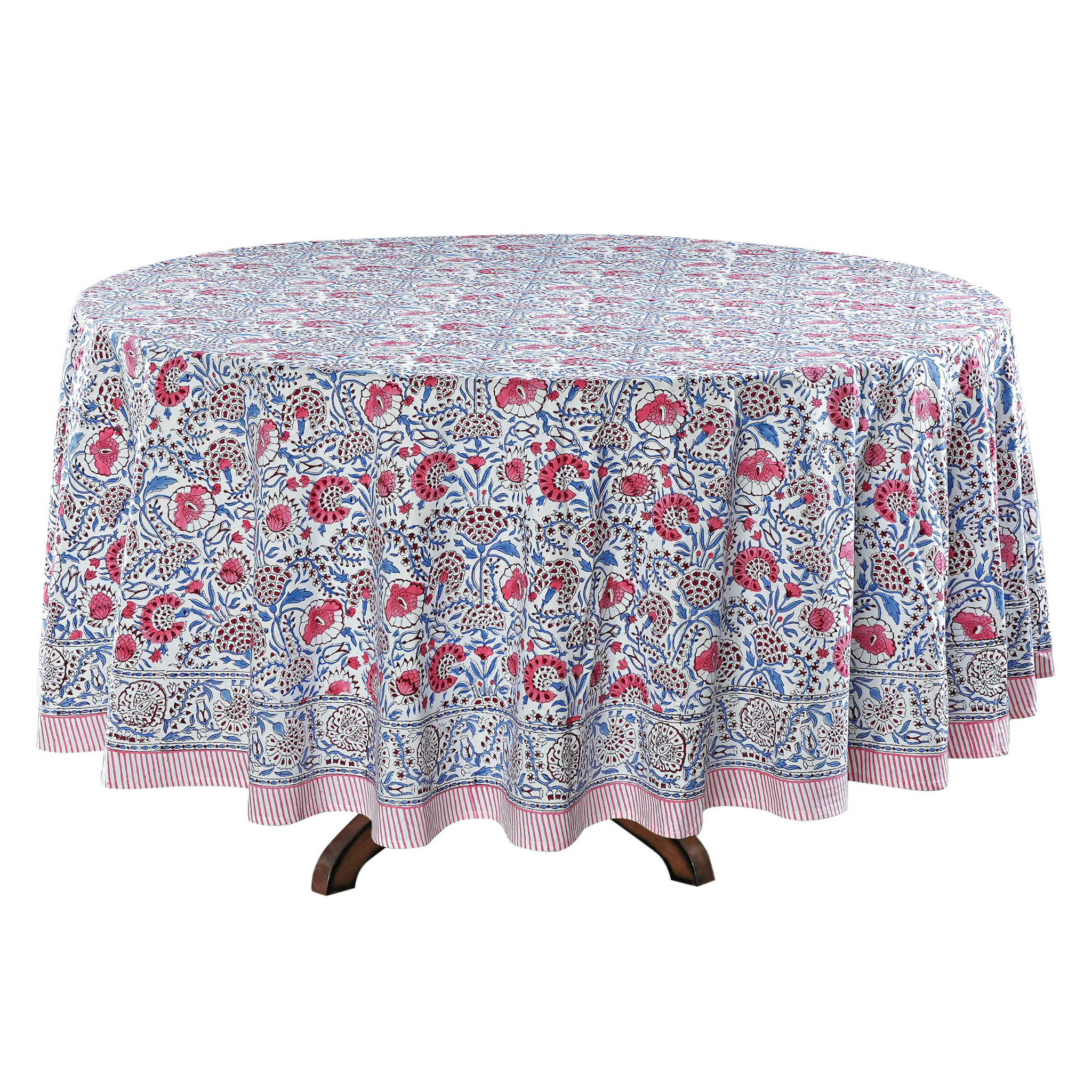 Round floral-patterned tablecloth on a wooden table with a white background