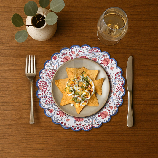Dinner setting with a plate of food, fork, knife, and glass on a wooden table.