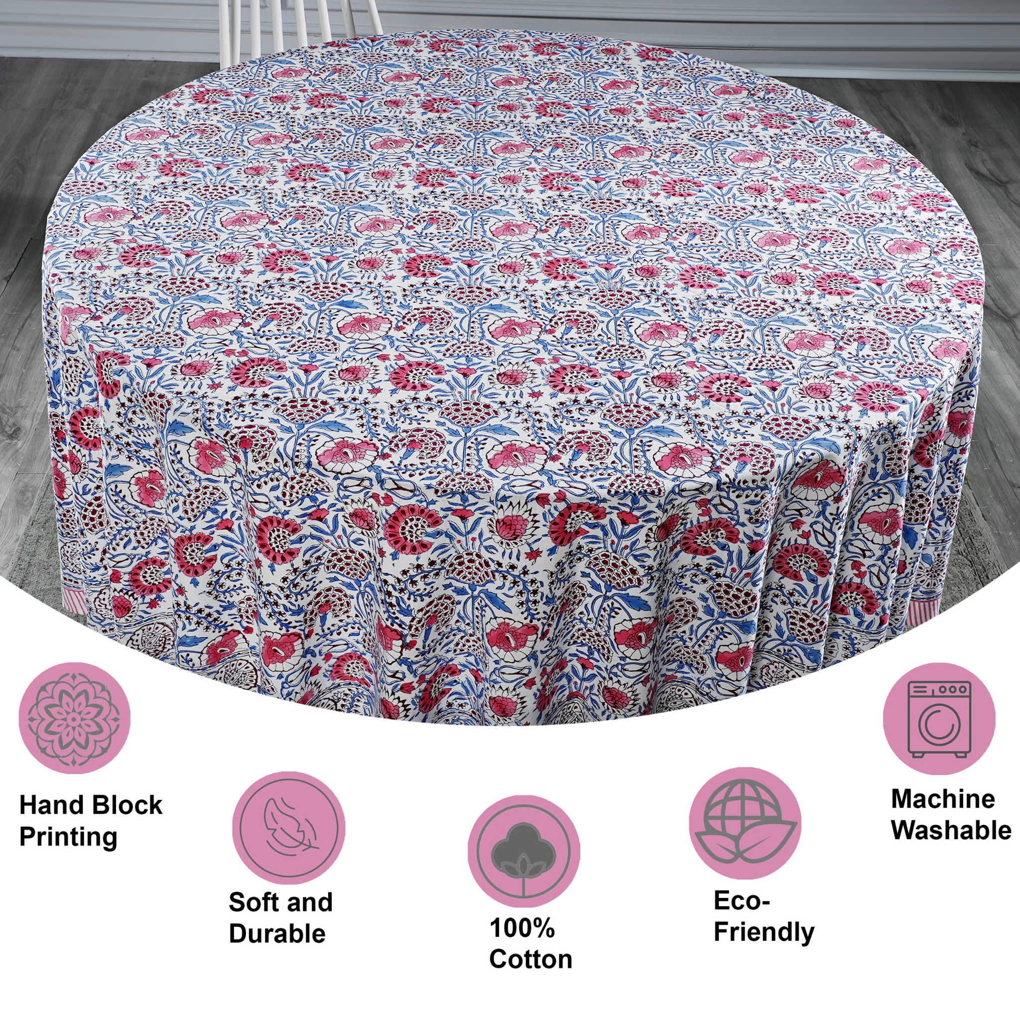 Round tablecloth with floral pattern on a wooden floor, featuring icons and text about material and care.