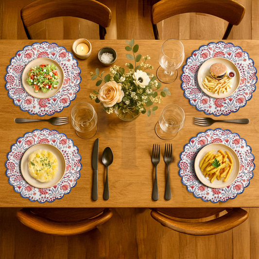 Dining table set with plates, cutlery, and a small bouquet of flowers.