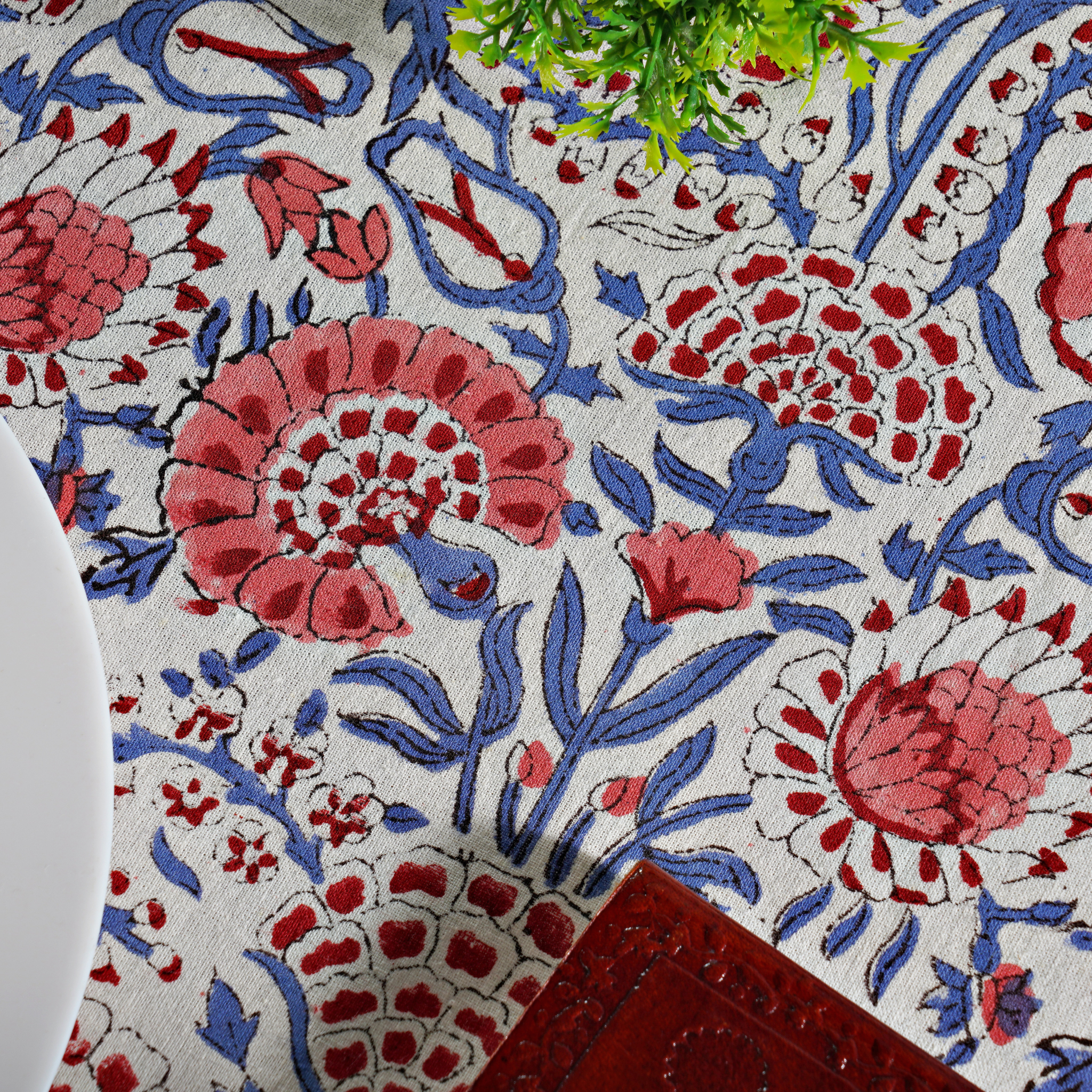 Close-up of a floral patterned fabric with red and blue colors.