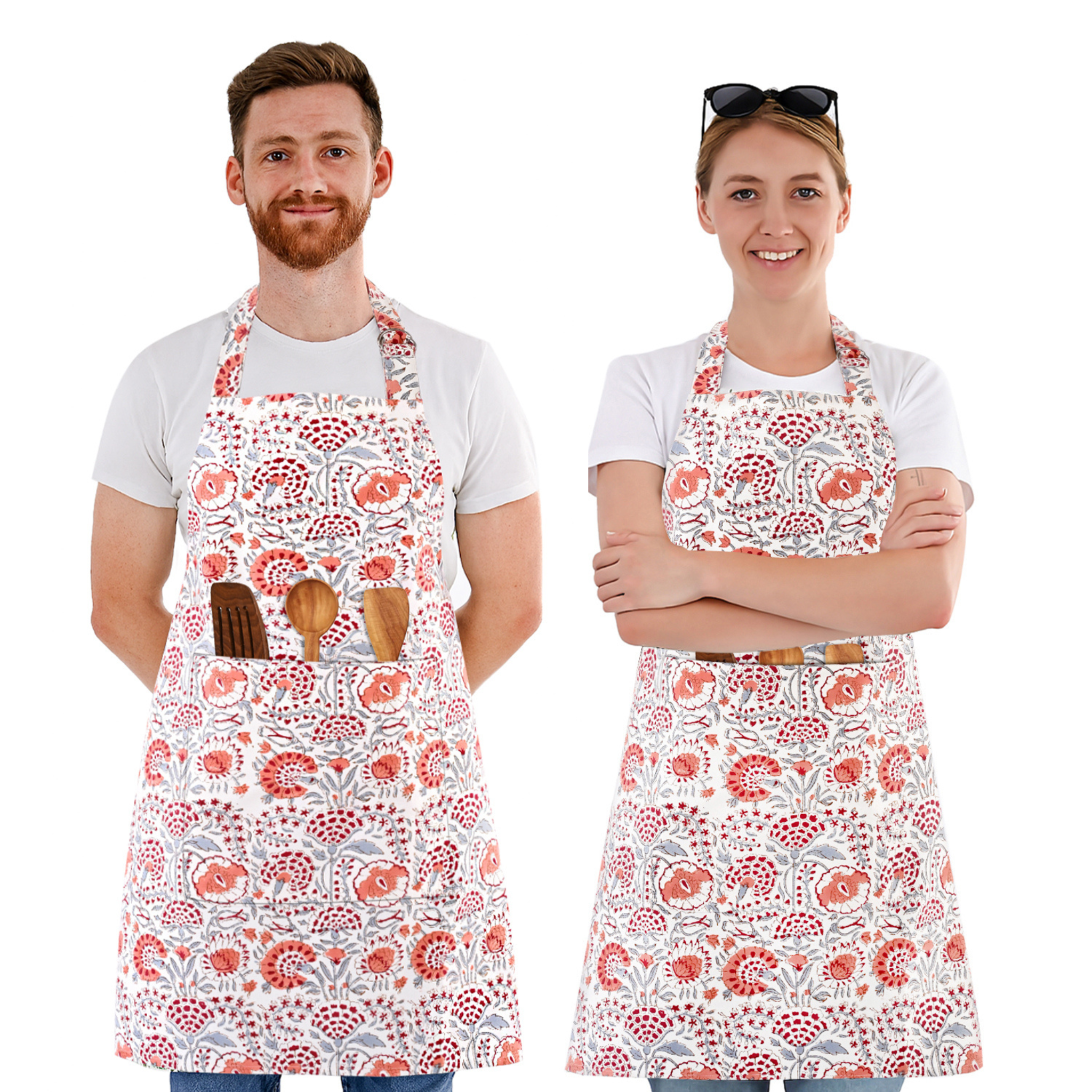 Two people wearing floral aprons on a white background