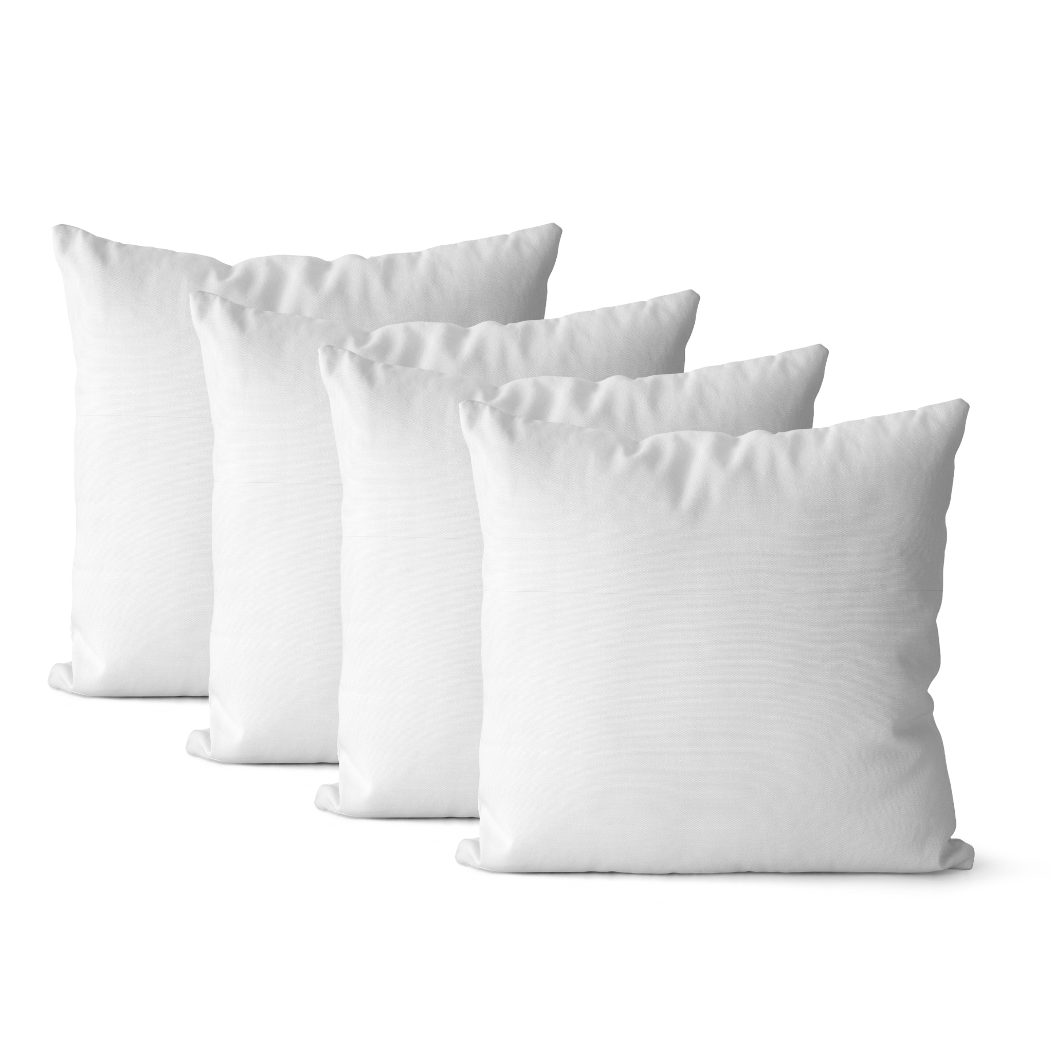 Set of four white pillow inserts on a white background