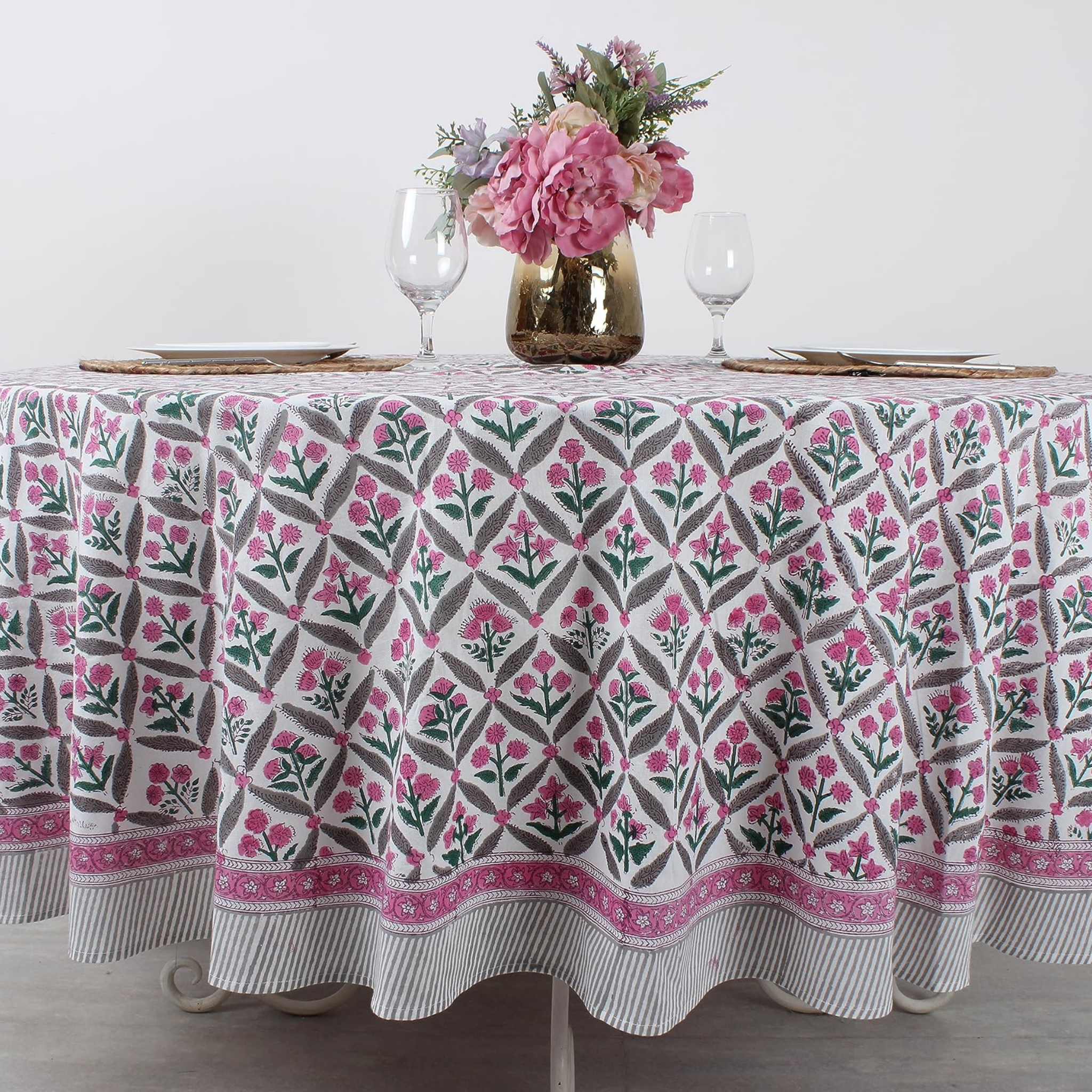 Tablecloth with floral pattern on a table set for dinner.