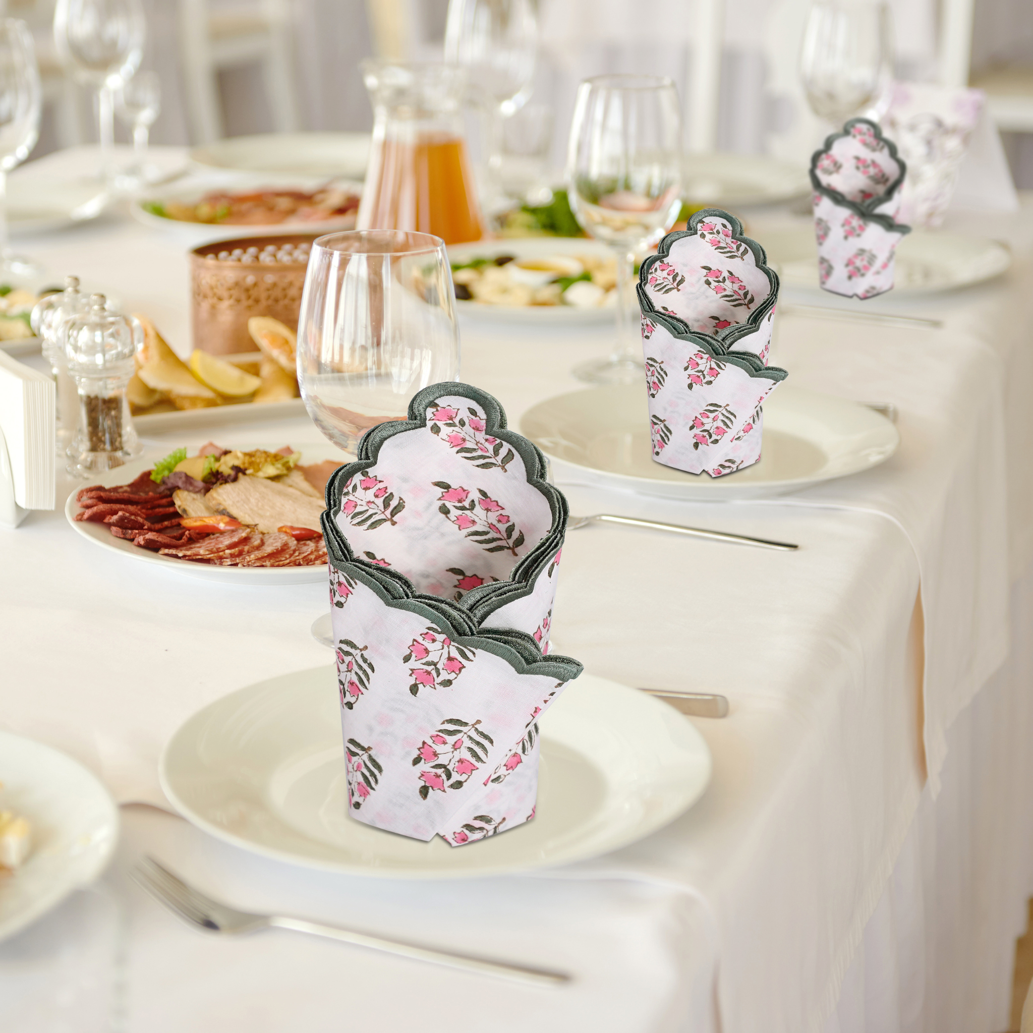 Decorative paper cups with floral design on a table setting.