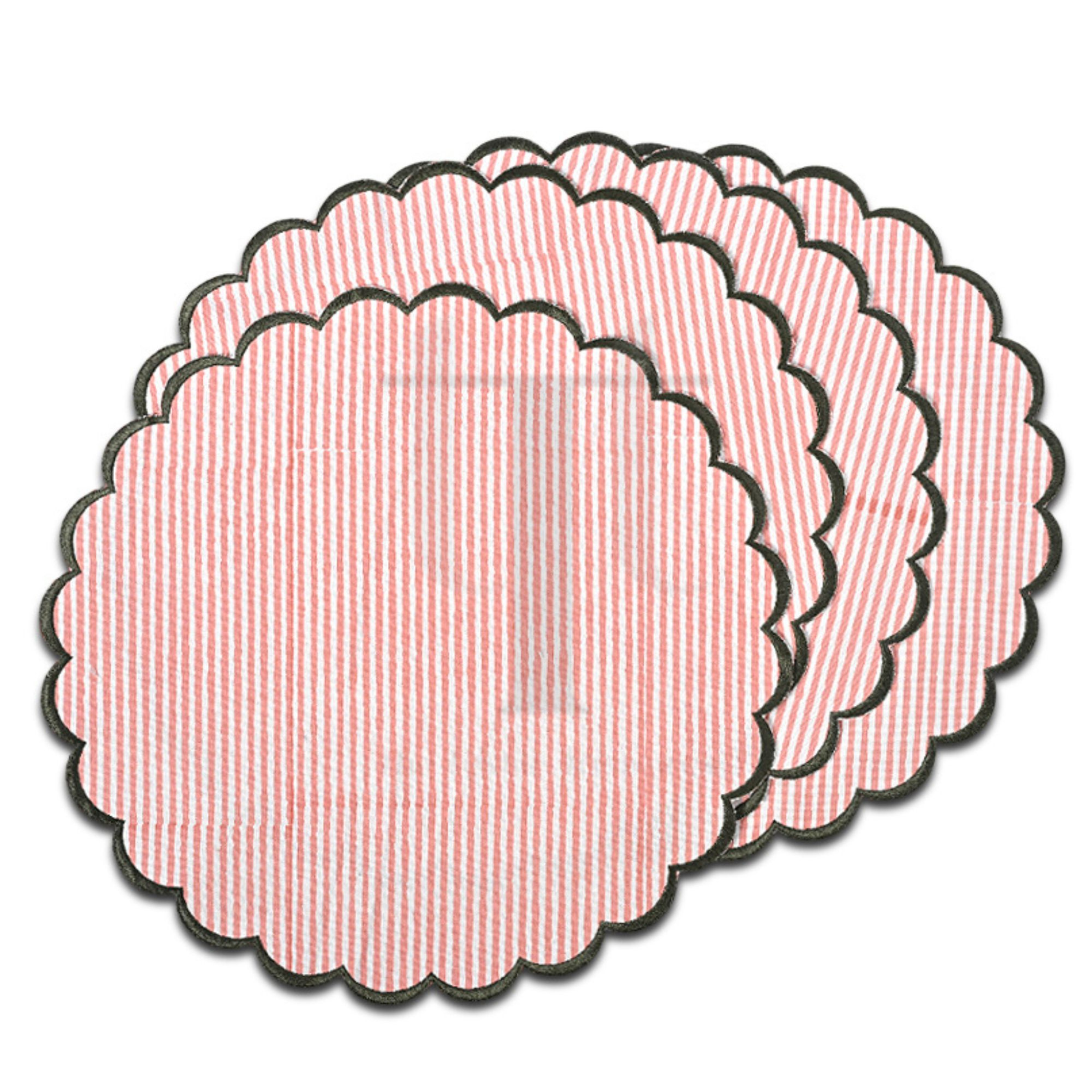Set of pink textured circular coasters on a white background