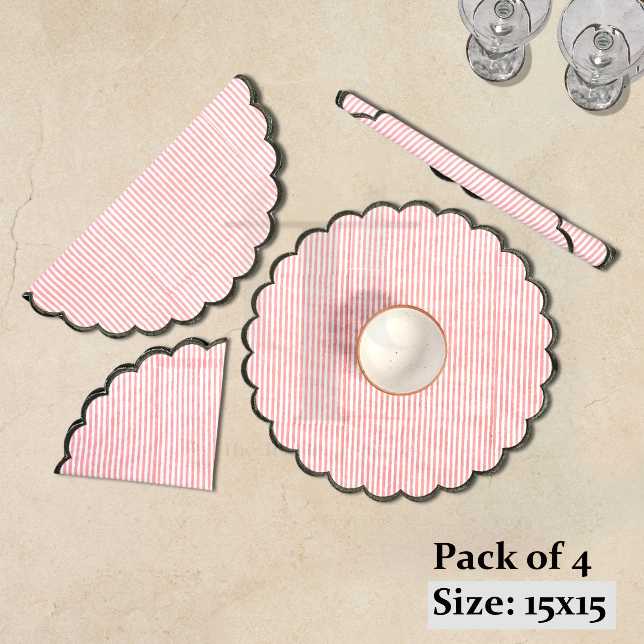 Pack of four pink and white patterned placemats on a beige surface.