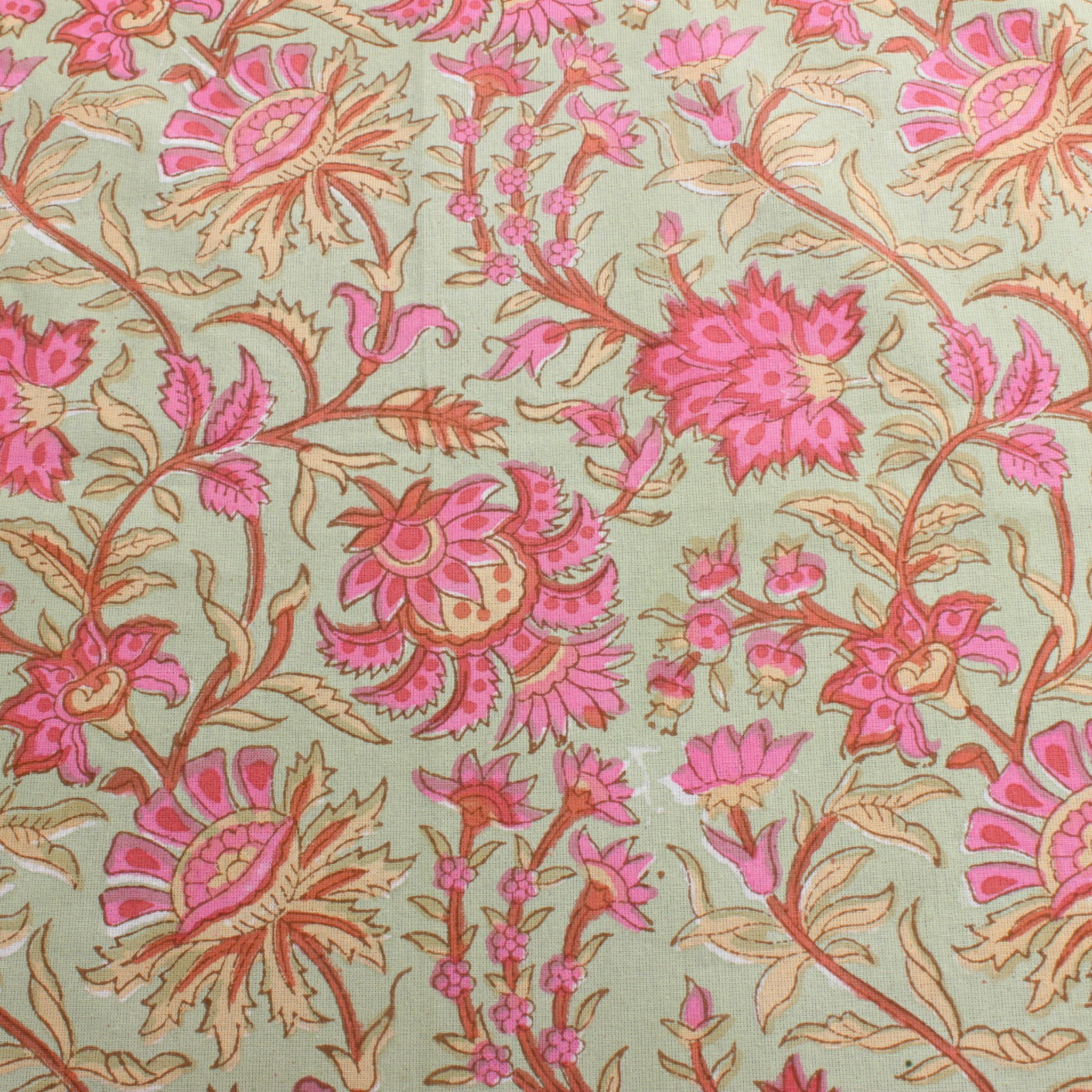 Patterned fabric with pink and orange flowers on a light green background