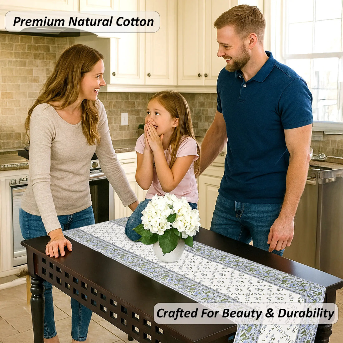Family in a kitchen with a table runner featuring white flowers.