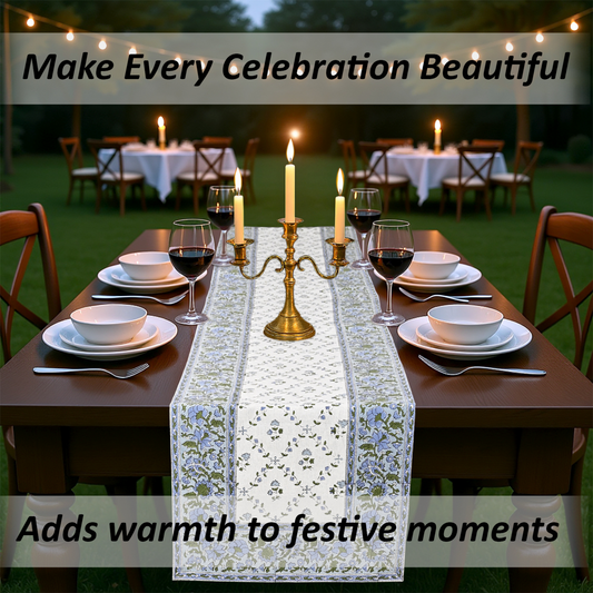 Dining table set for an outdoor celebration with candles and a decorative table runner.
