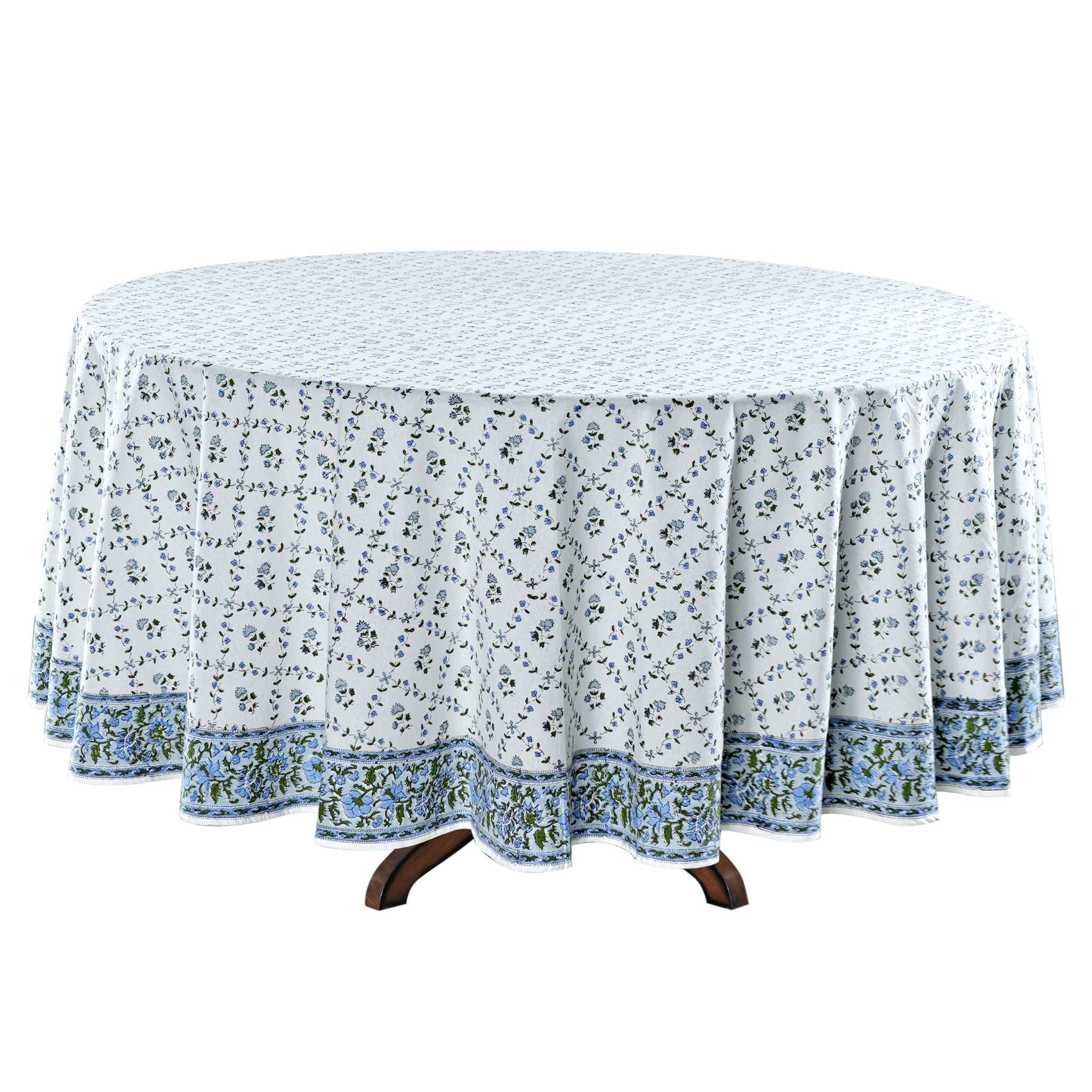 Round table with a floral patterned tablecloth on a white background