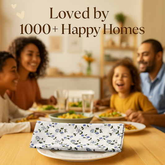 Family enjoying a meal together with a floral-patterned tablecloth on a table.