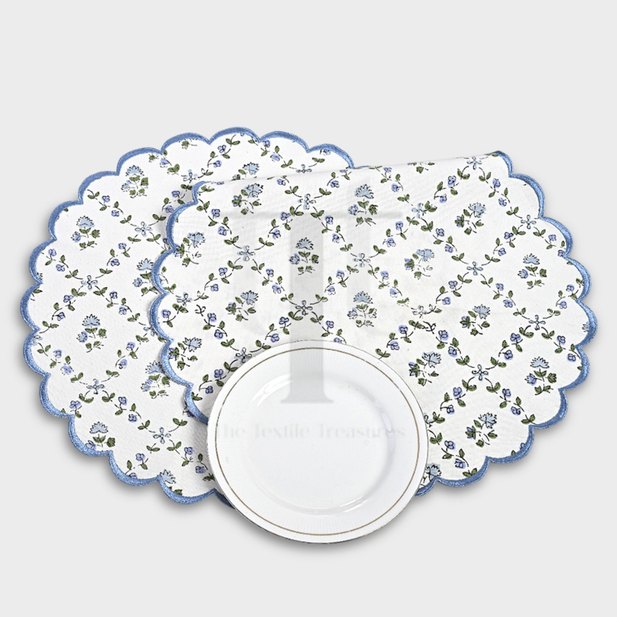 Floral-patterned placemat with scalloped edge on a white background