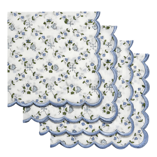 Set of floral table mats with scalloped edges on a white background