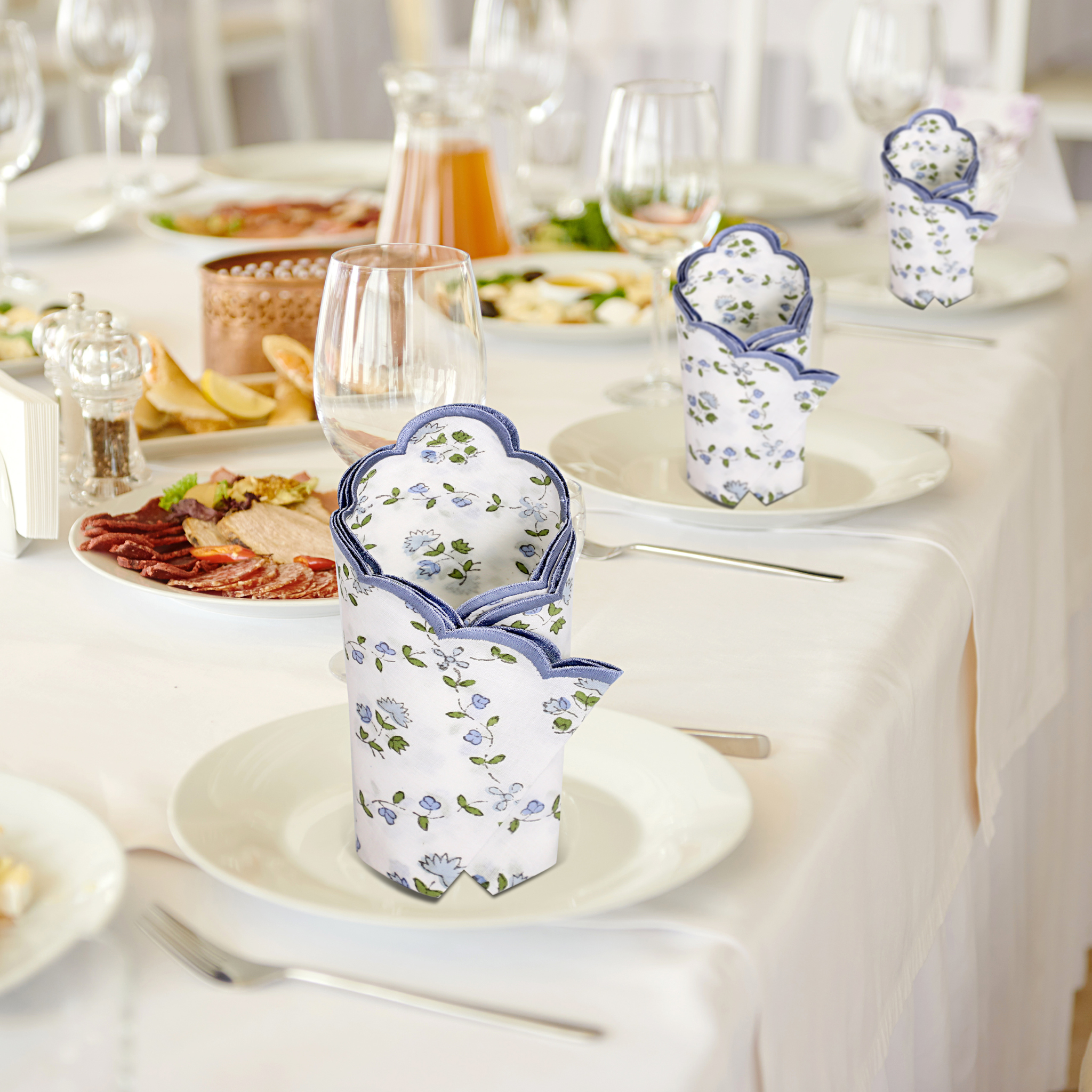 Decorative floral cups on a table with a meal setup