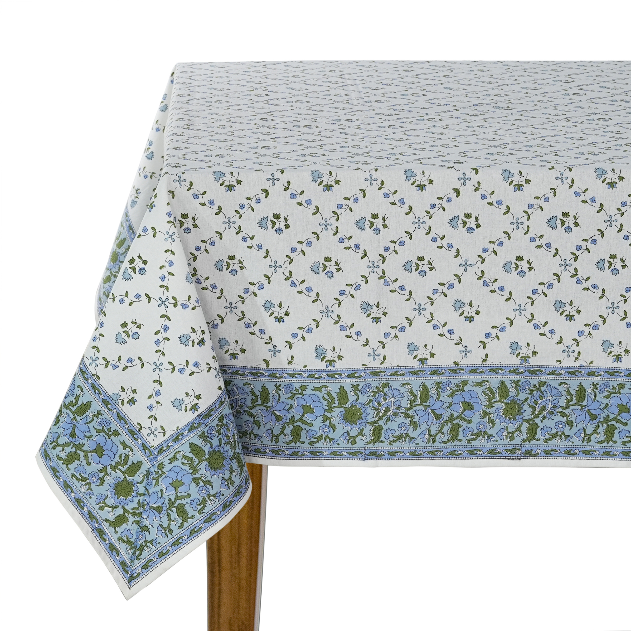 Floral patterned tablecloth on a wooden table with a white background