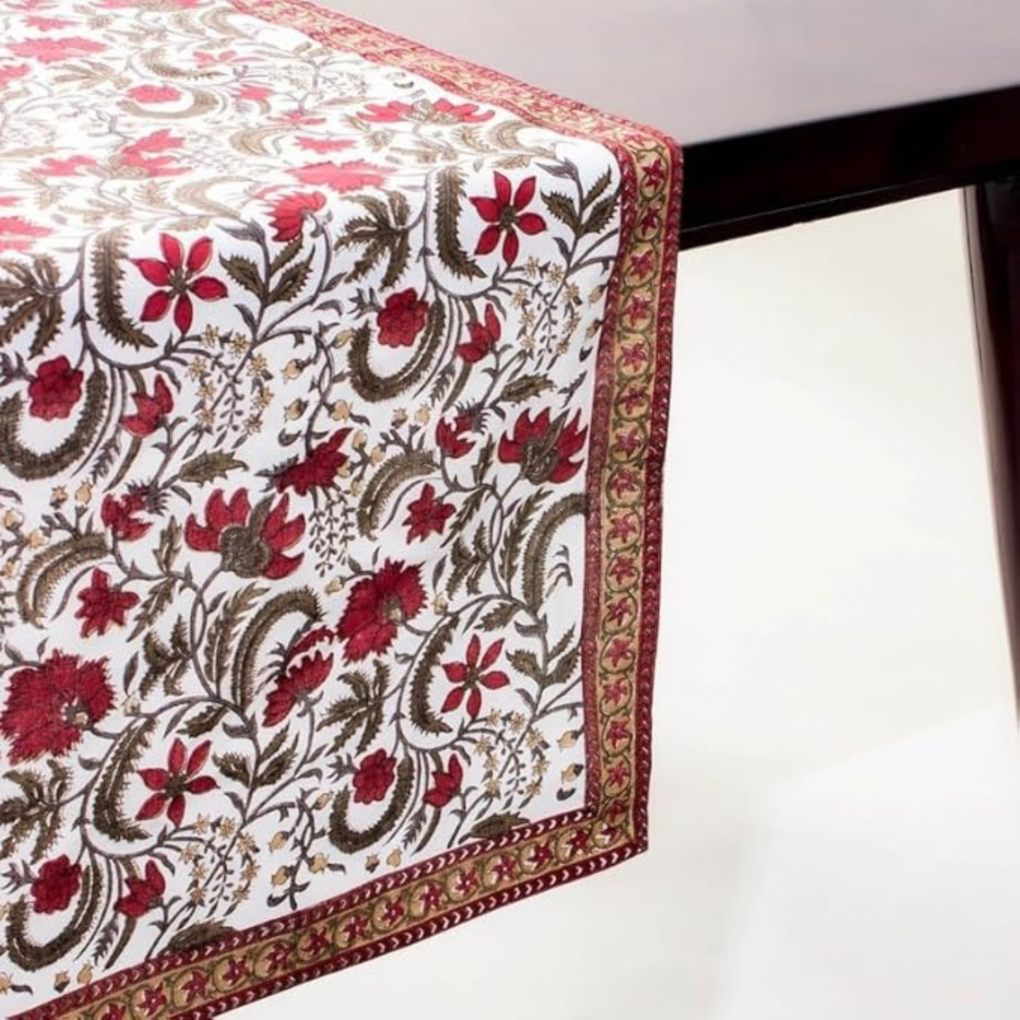 Floral patterned table runner on a white surface