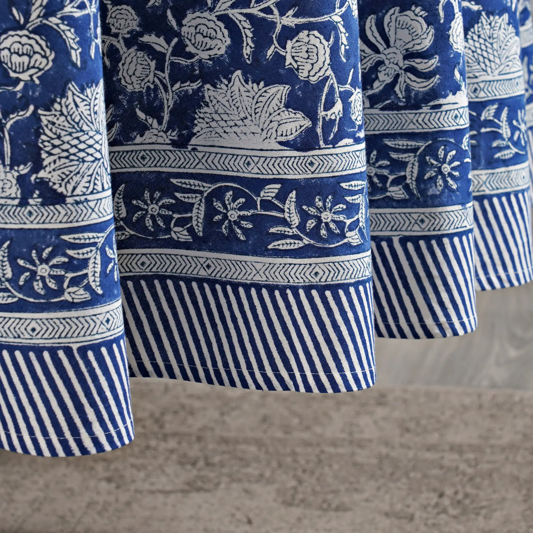 Close-up of blue and white patterned fabric with a neutral background