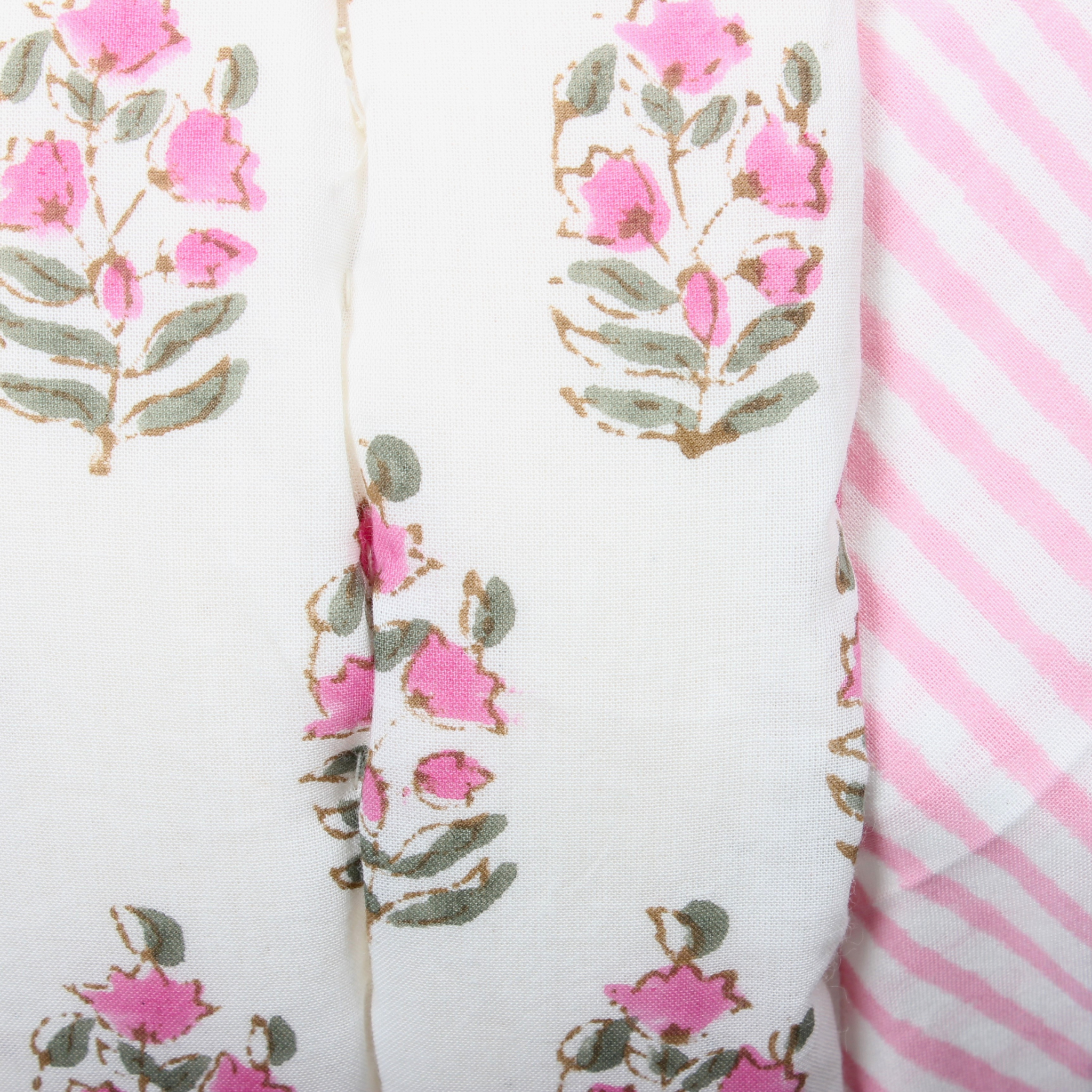 Two fabric swatches with floral pattern and pink stripes on a white background