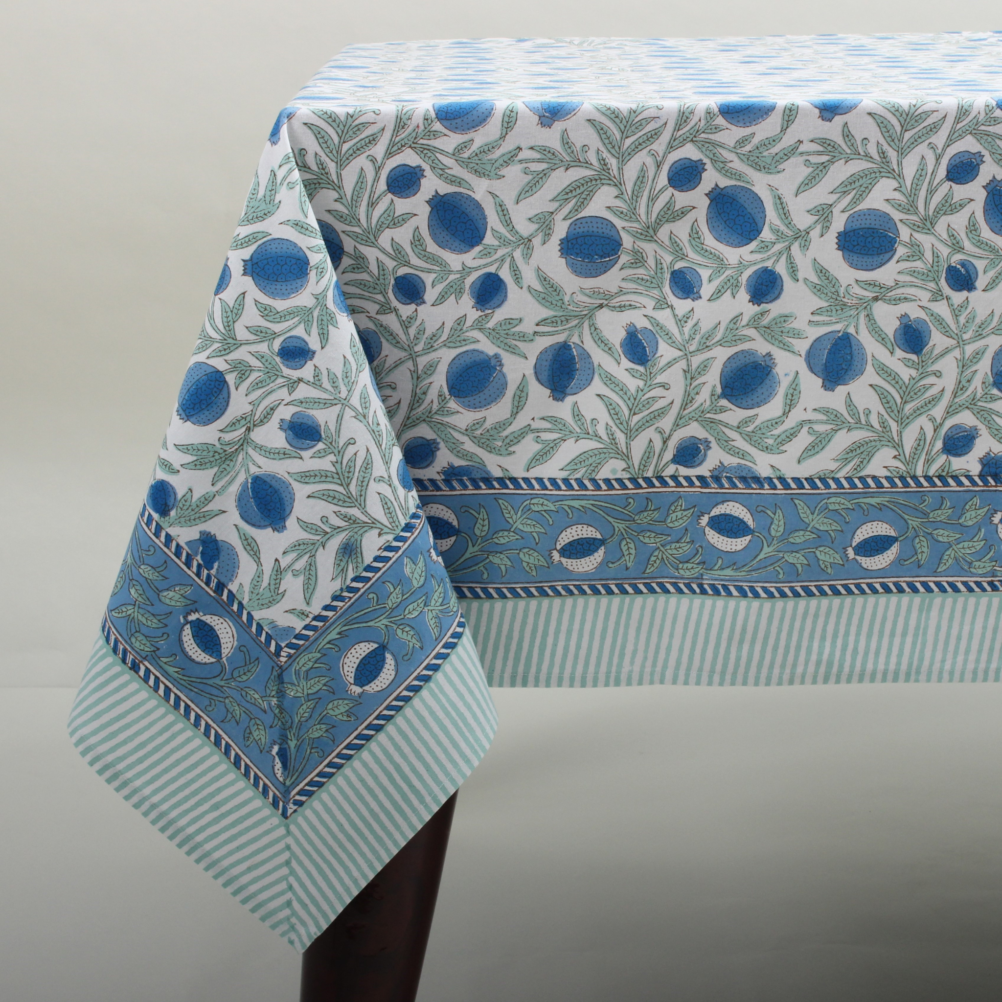 Tablecloth with blue and green floral pattern on a white background