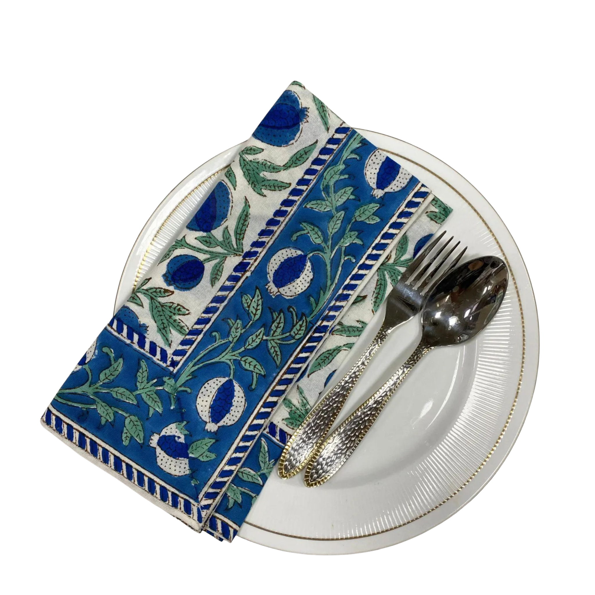 Decorative blue and green patterned napkin on a white plate with silverware.