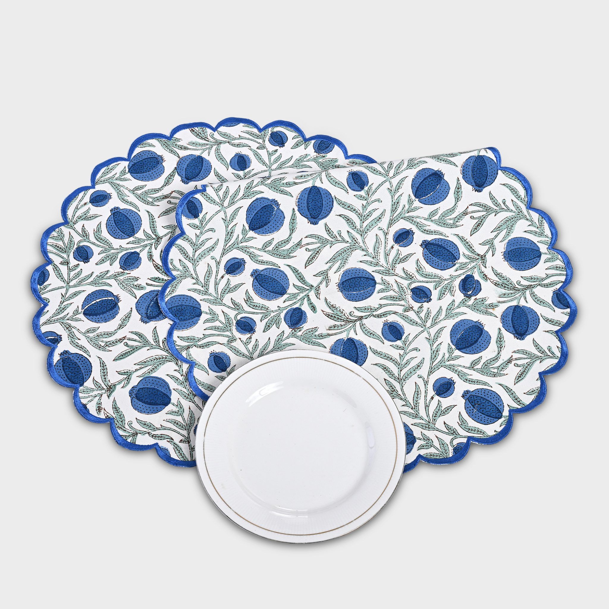 Set of decorative placemats with blue and green pattern on a white background