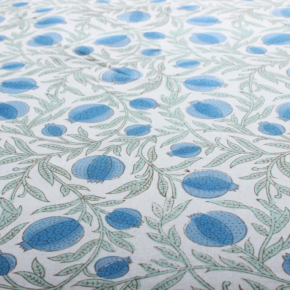 Patterned fabric with blue and green design on a white background