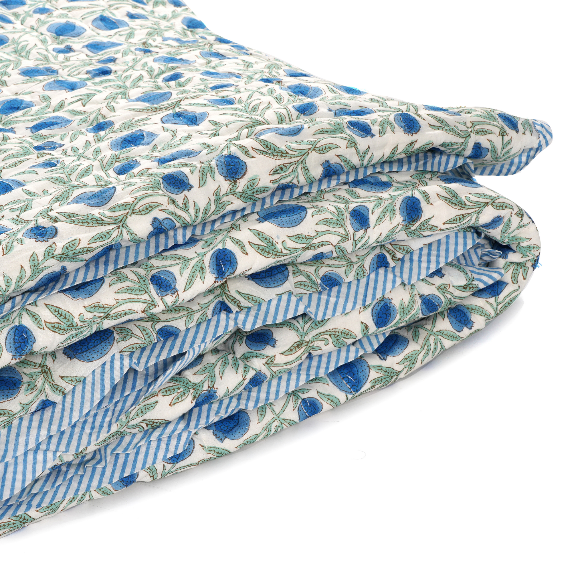 Folded fabric with blue and green pattern on a white background