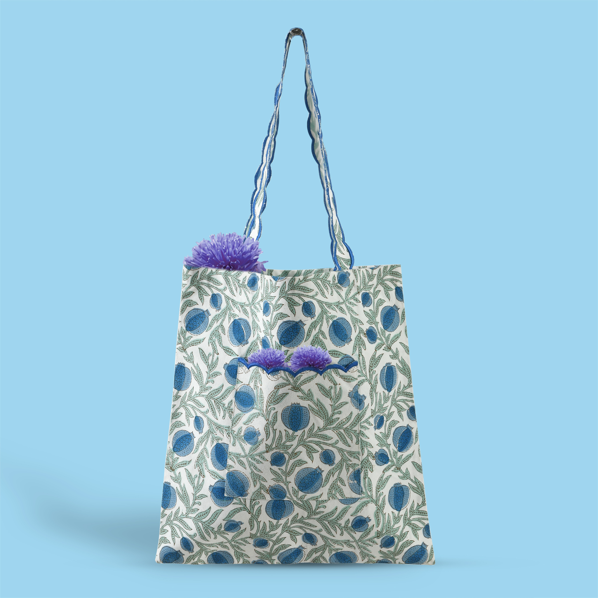 Floral-patterned tote bag with plants on a blue background