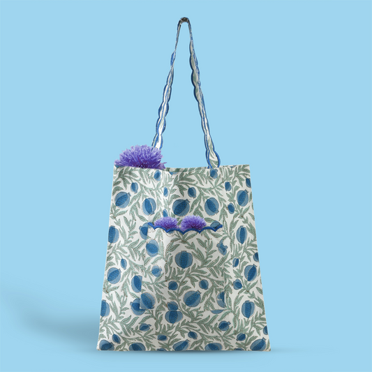 Floral-patterned tote bag with plants on a blue background