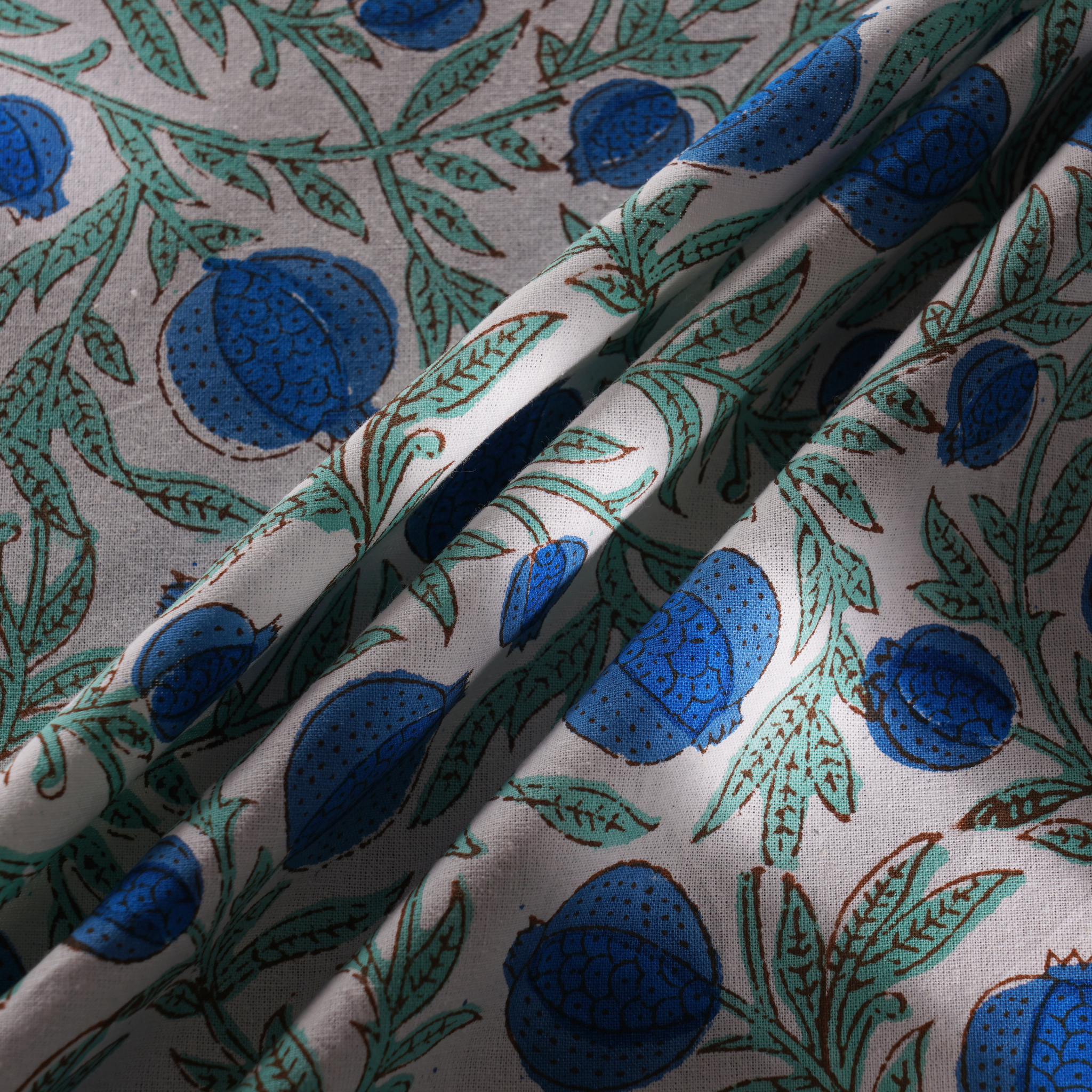 Close-up of fabric with blue floral pattern on a gray background