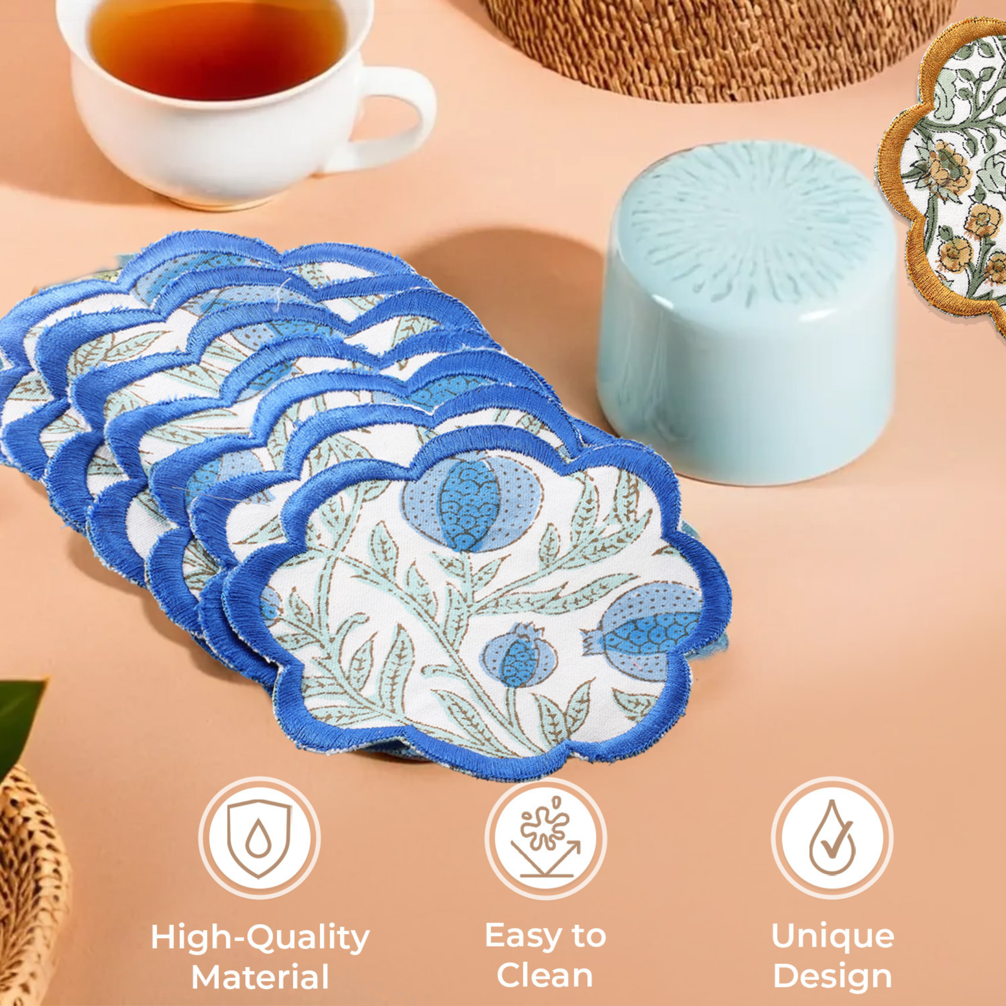 Set of floral coasters with a cup of tea and decorative items on a beige surface