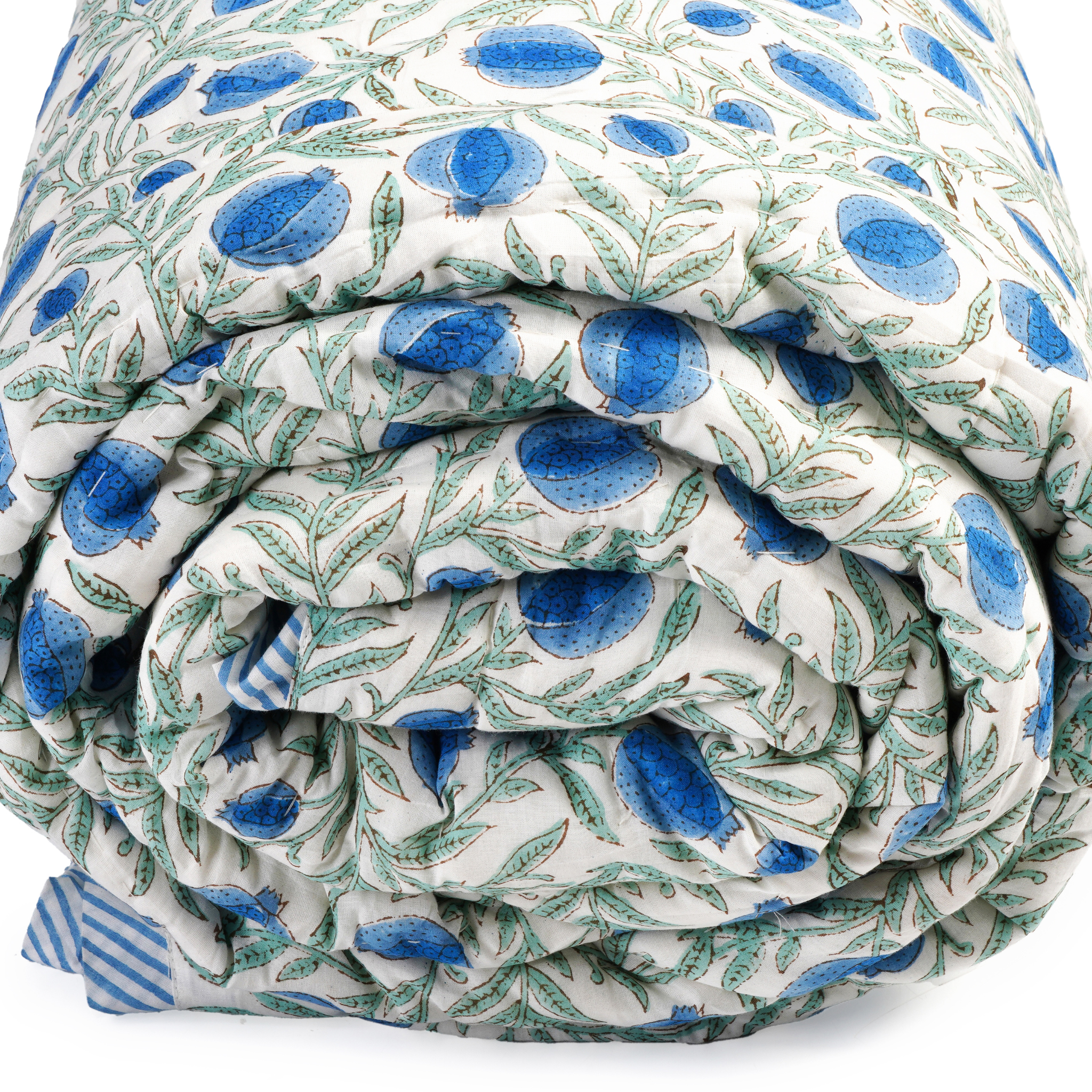 Folded fabric with blue and green pattern on a white background
