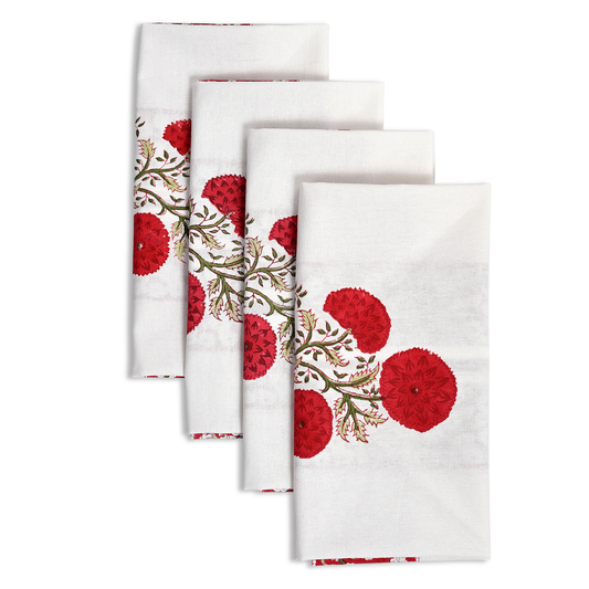 Set of four white napkins with red floral patterns on a white background