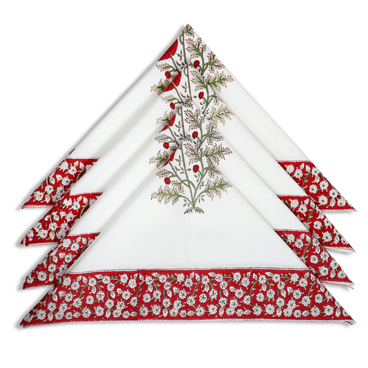 Set of four napkins with floral and leaf patterns on a white background